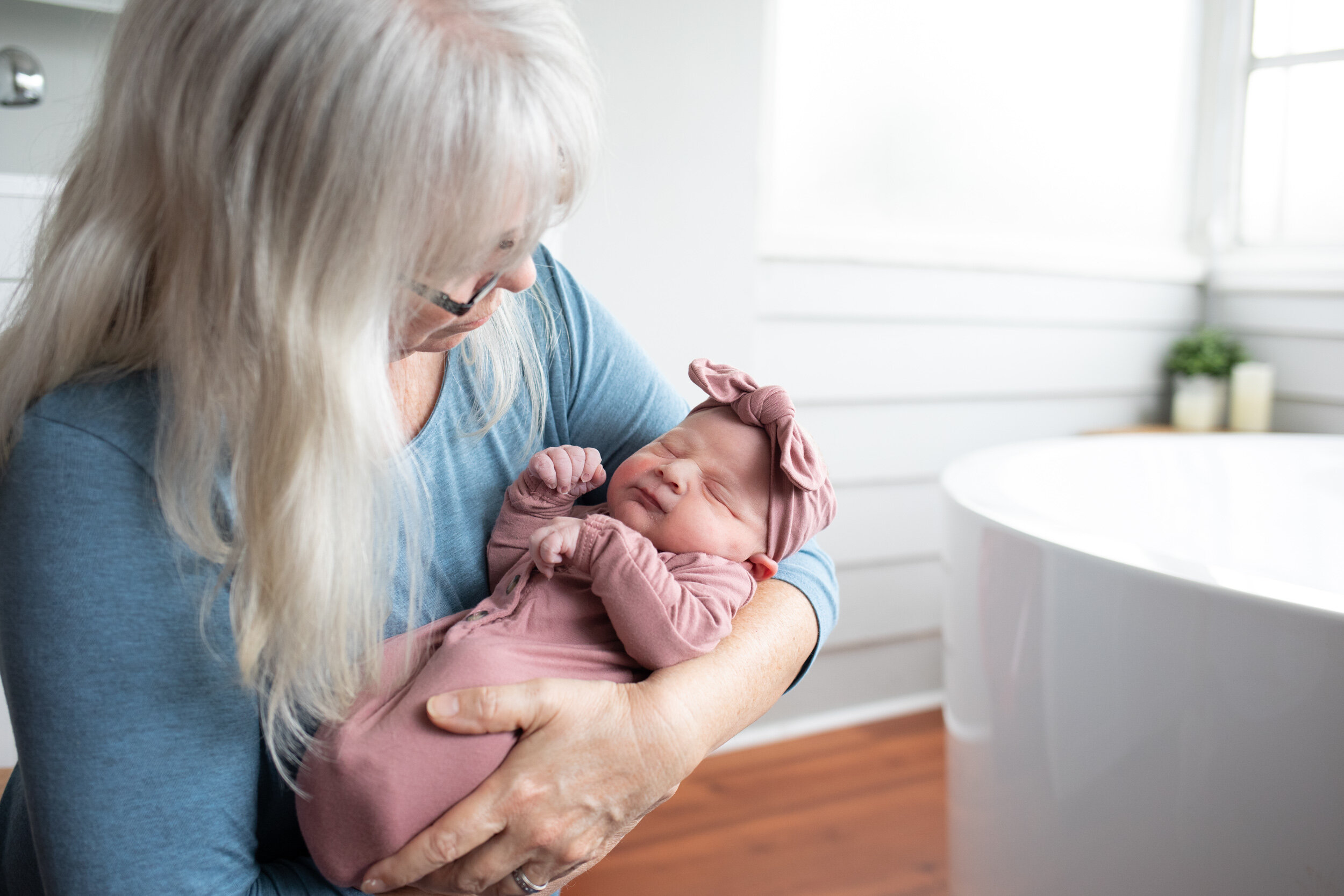 Grandmother holding her newborn baby granddaughter