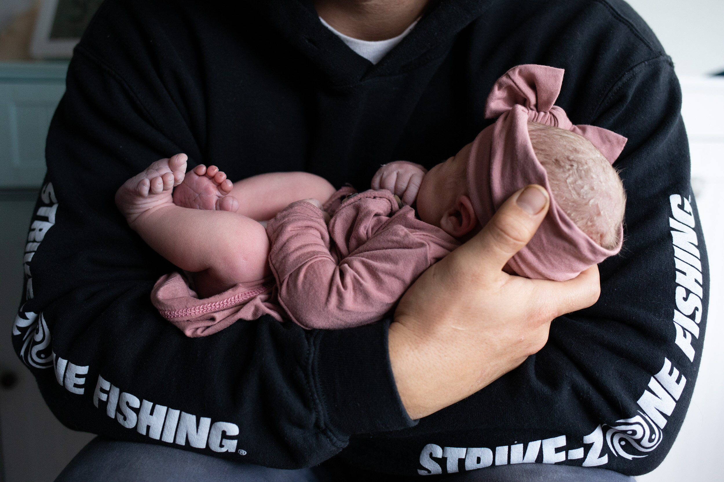 Jacksonville dad holding newborn baby girl after birth