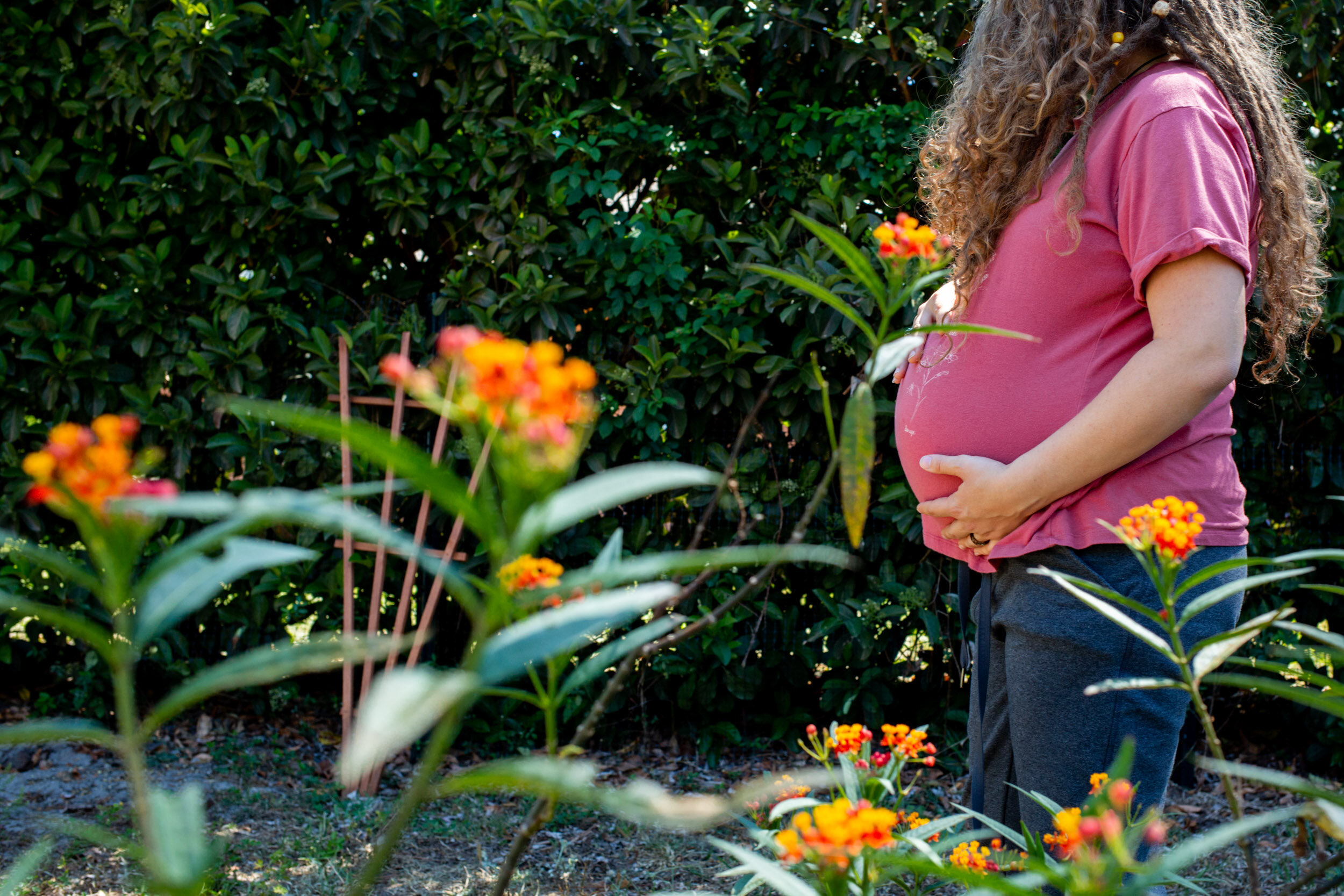 St. Augustine birth mom walking through her garden while in labor