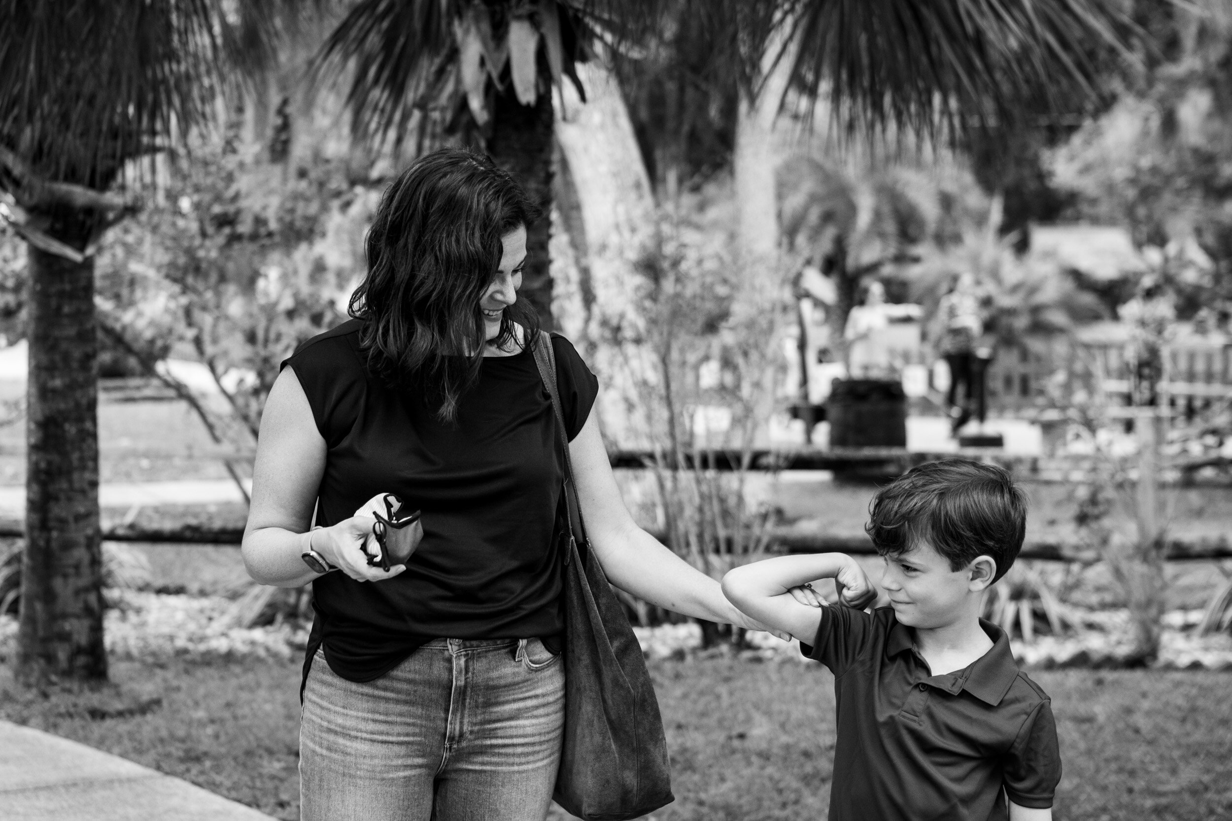 Little boy showing his mom his muscles