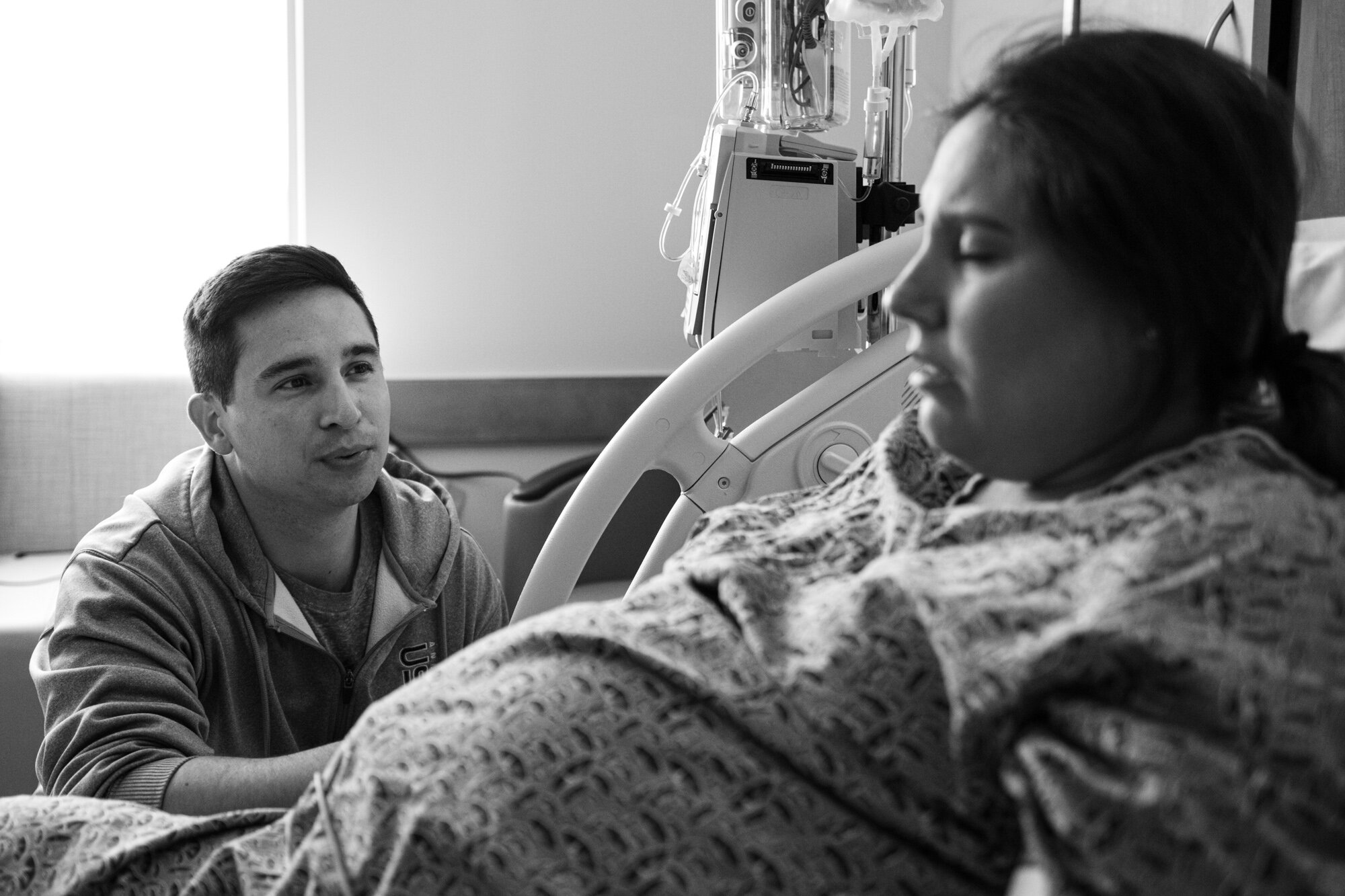 husband sitting by his pregnant wife during a contraction