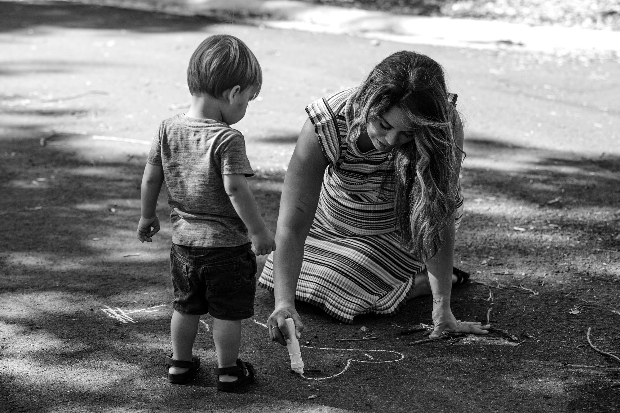 mom drawing heart with sidewalk chalk