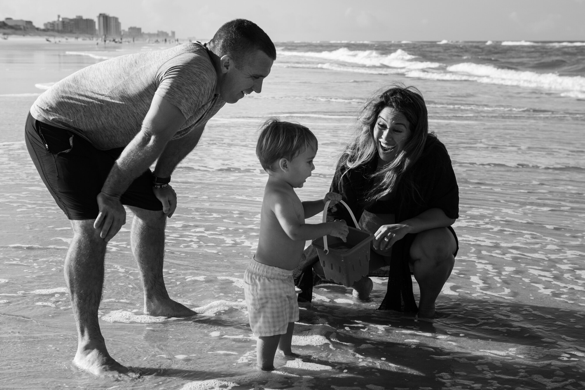 family playing on the beach