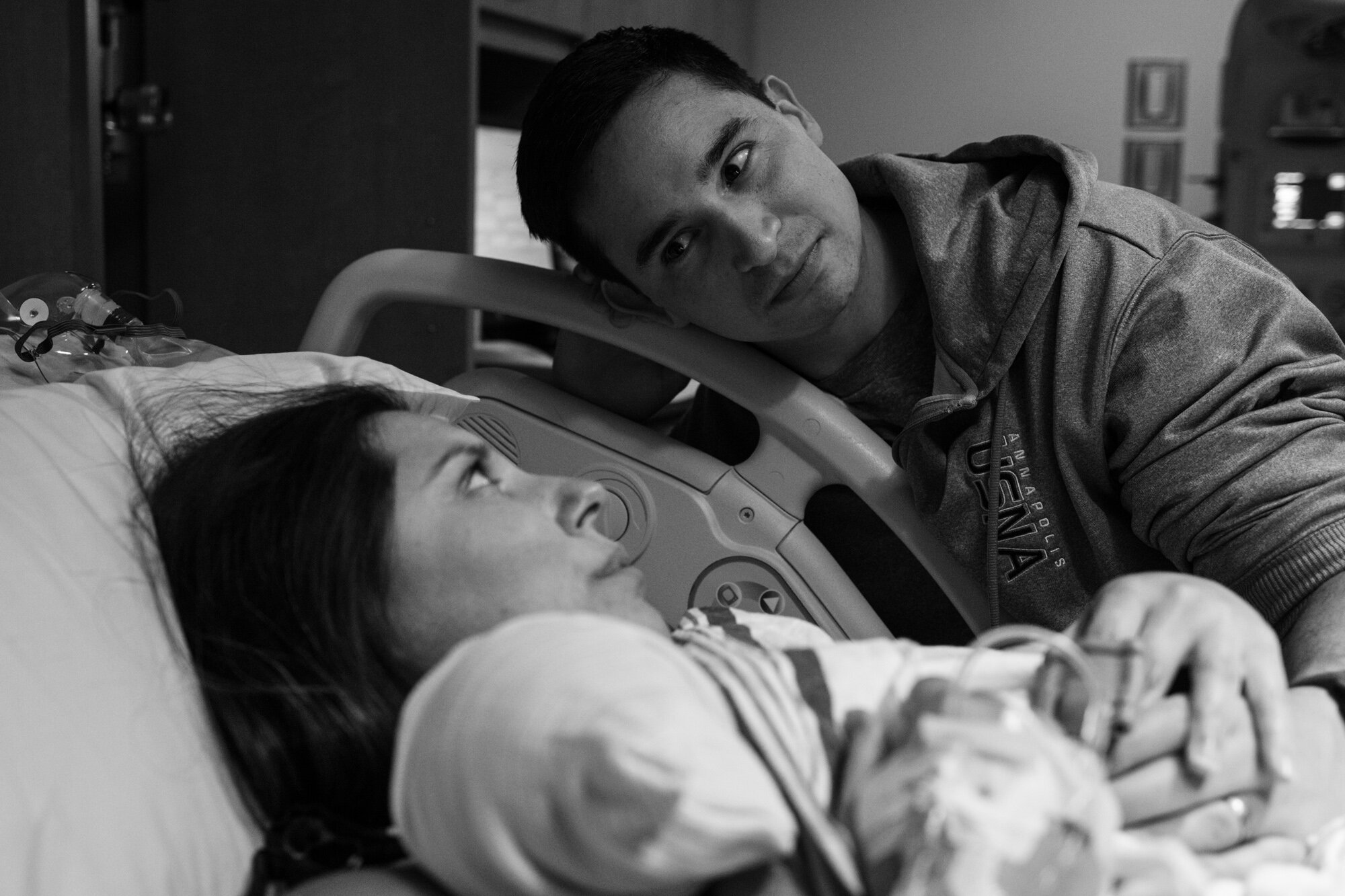 jacksonville parents looking at each other intently, just after their baby was born