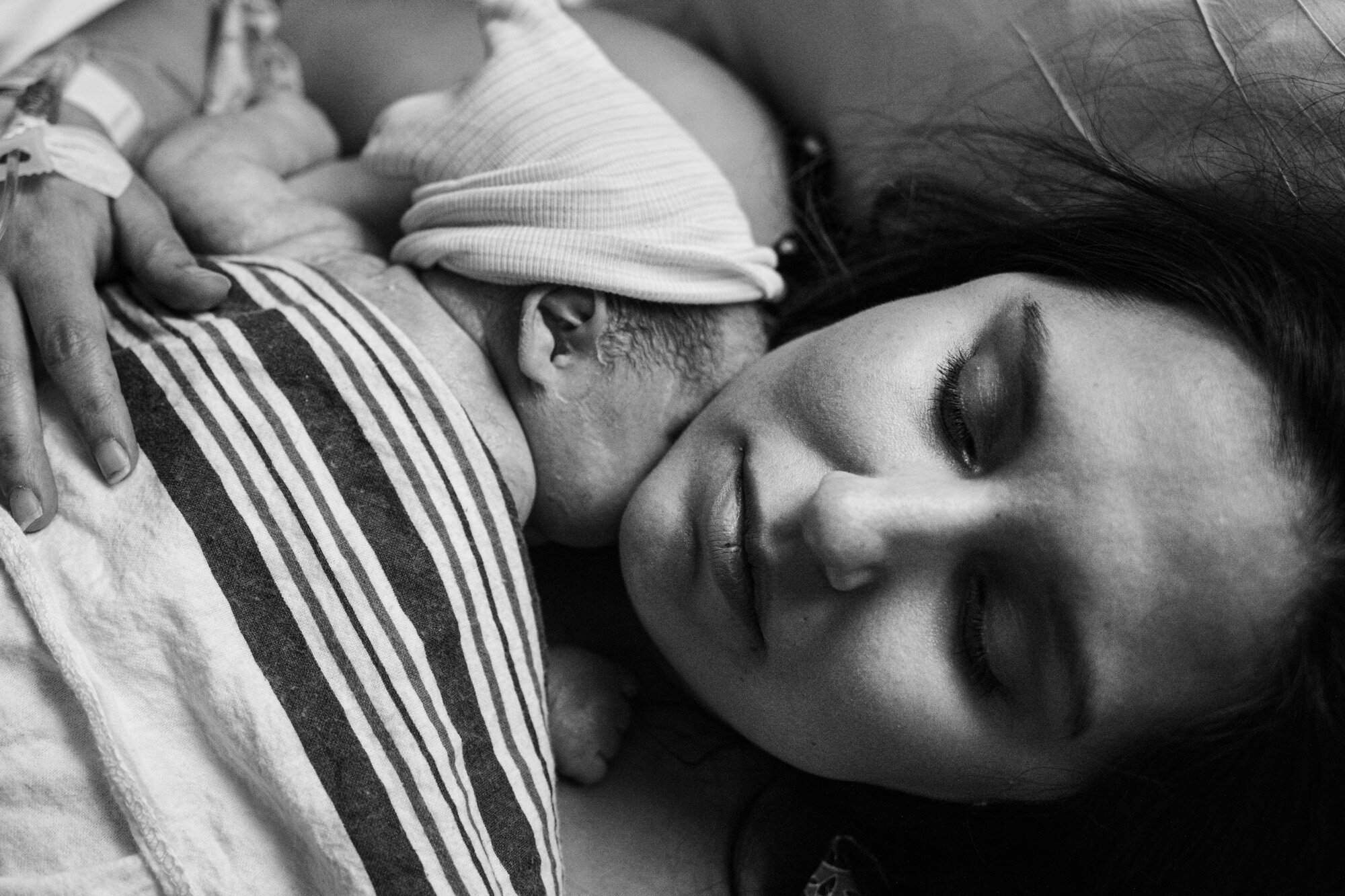 jacksonville birth mom resting while holding her newborn baby boy