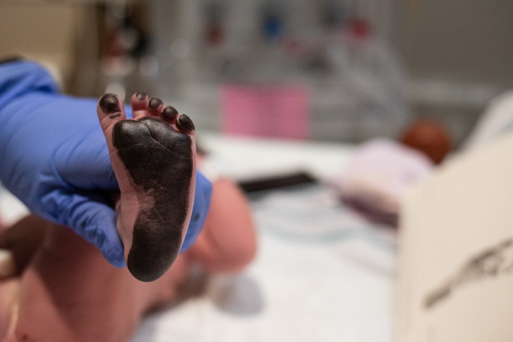 newborn baby foot covered in ink