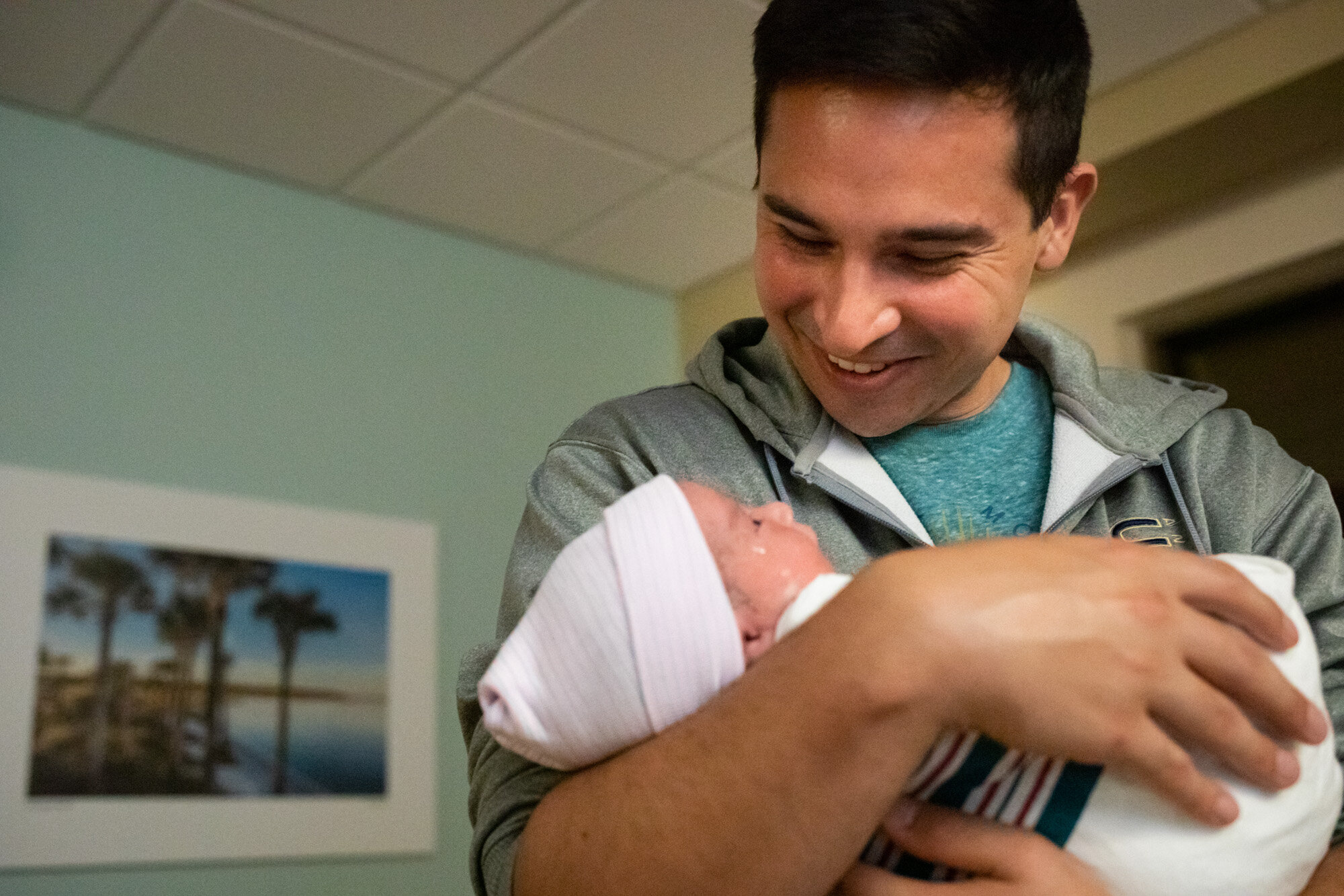 new dad holding his baby just after birth