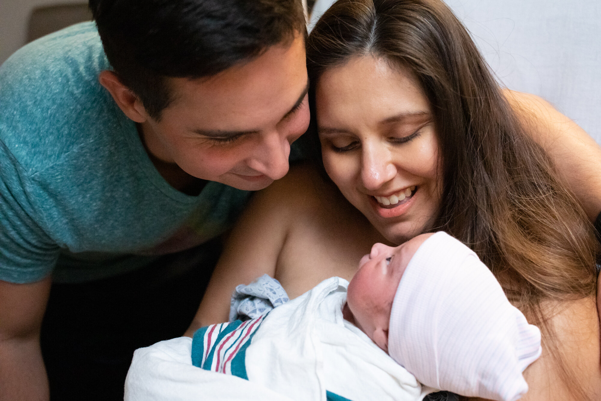 new parents marveling at their newborn baby boy