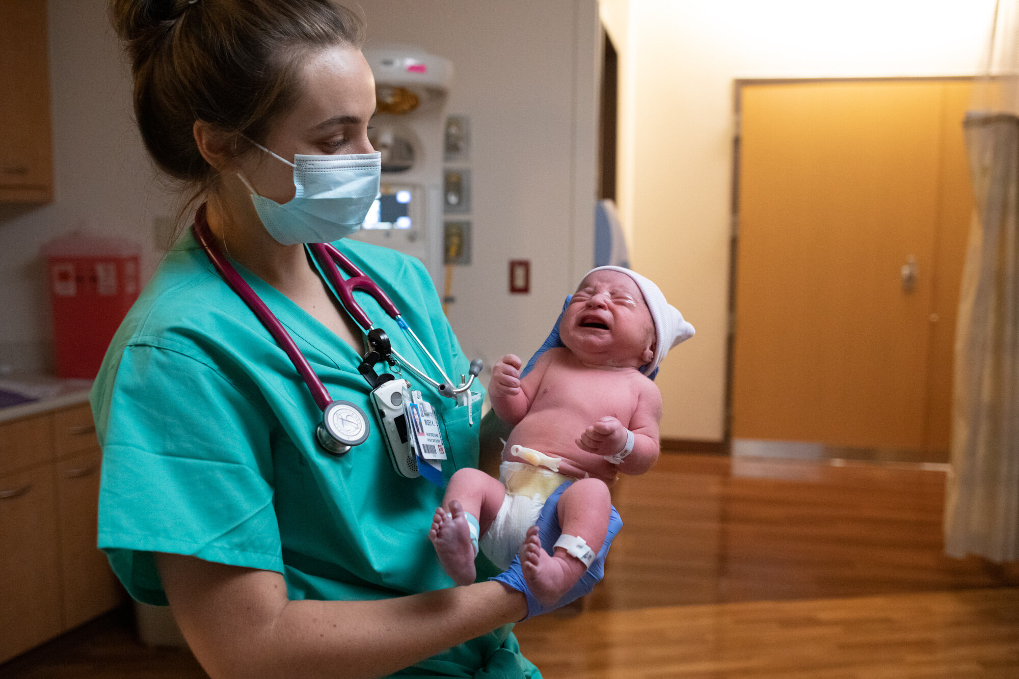 nurse holding newborn baby boy