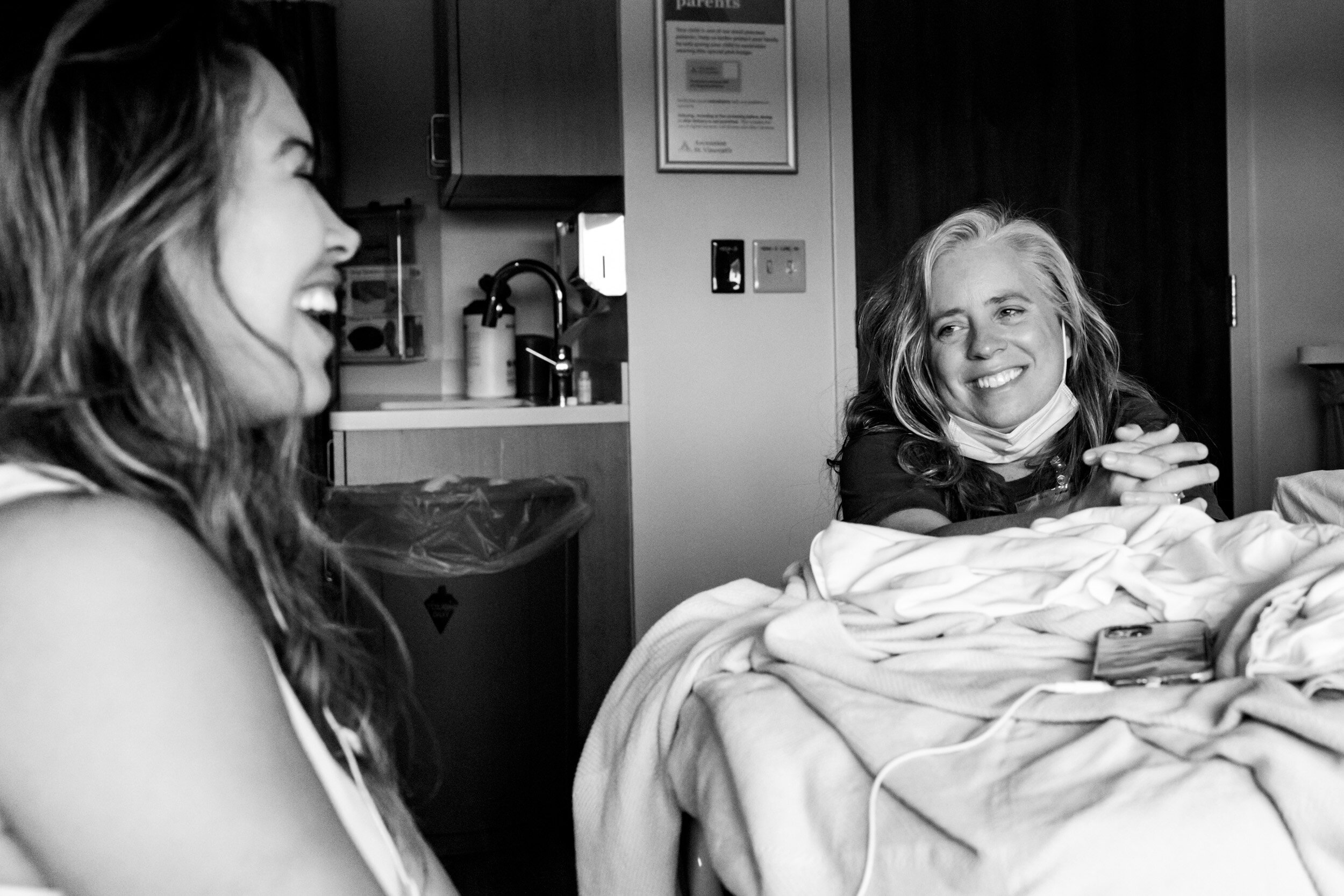 doula laughing with her client during labor