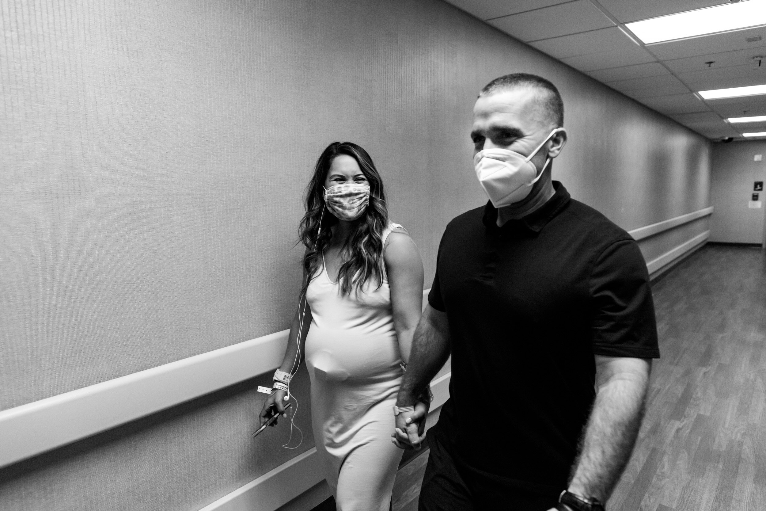 laboring mom and husband walking through the halls at the hospital
