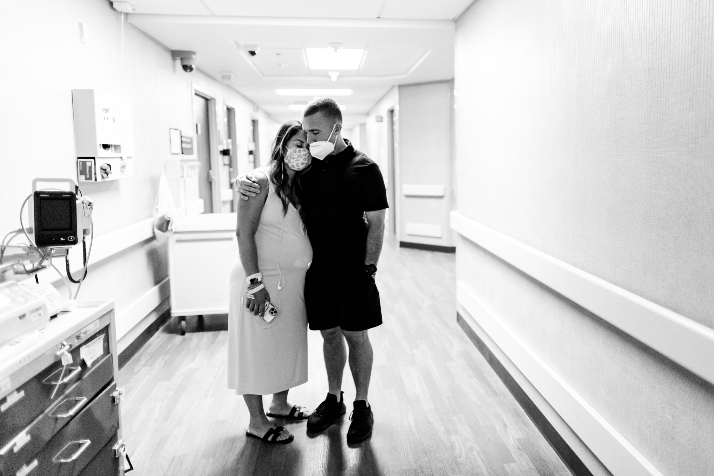 husband supporting wife during a contraction in the hospital wall