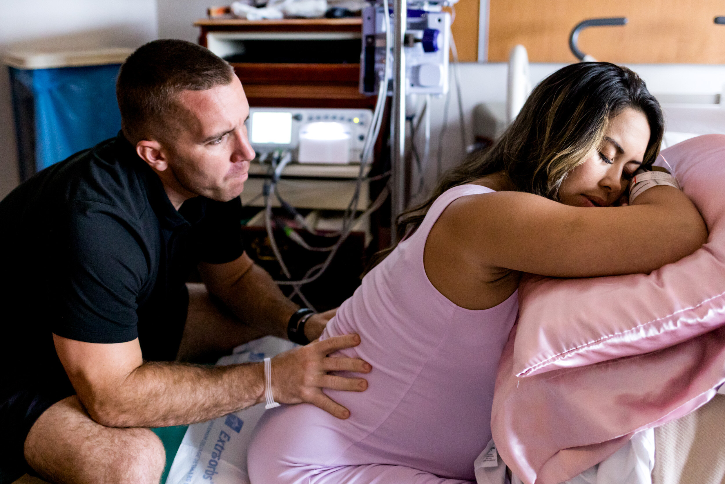 husband giving wife a back massage while in labor