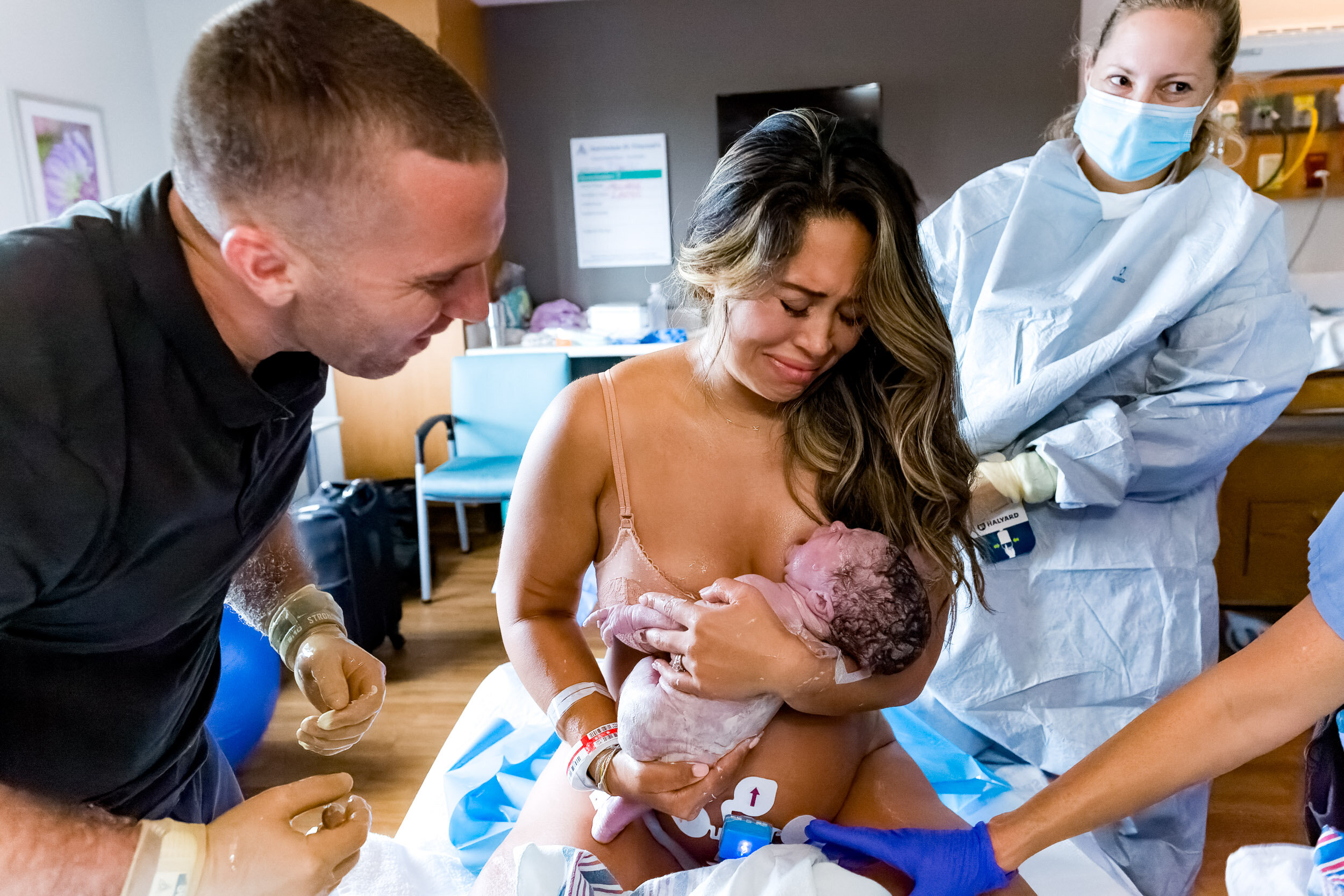 tears beginning to flow as new parents behold their baby girl just after birth