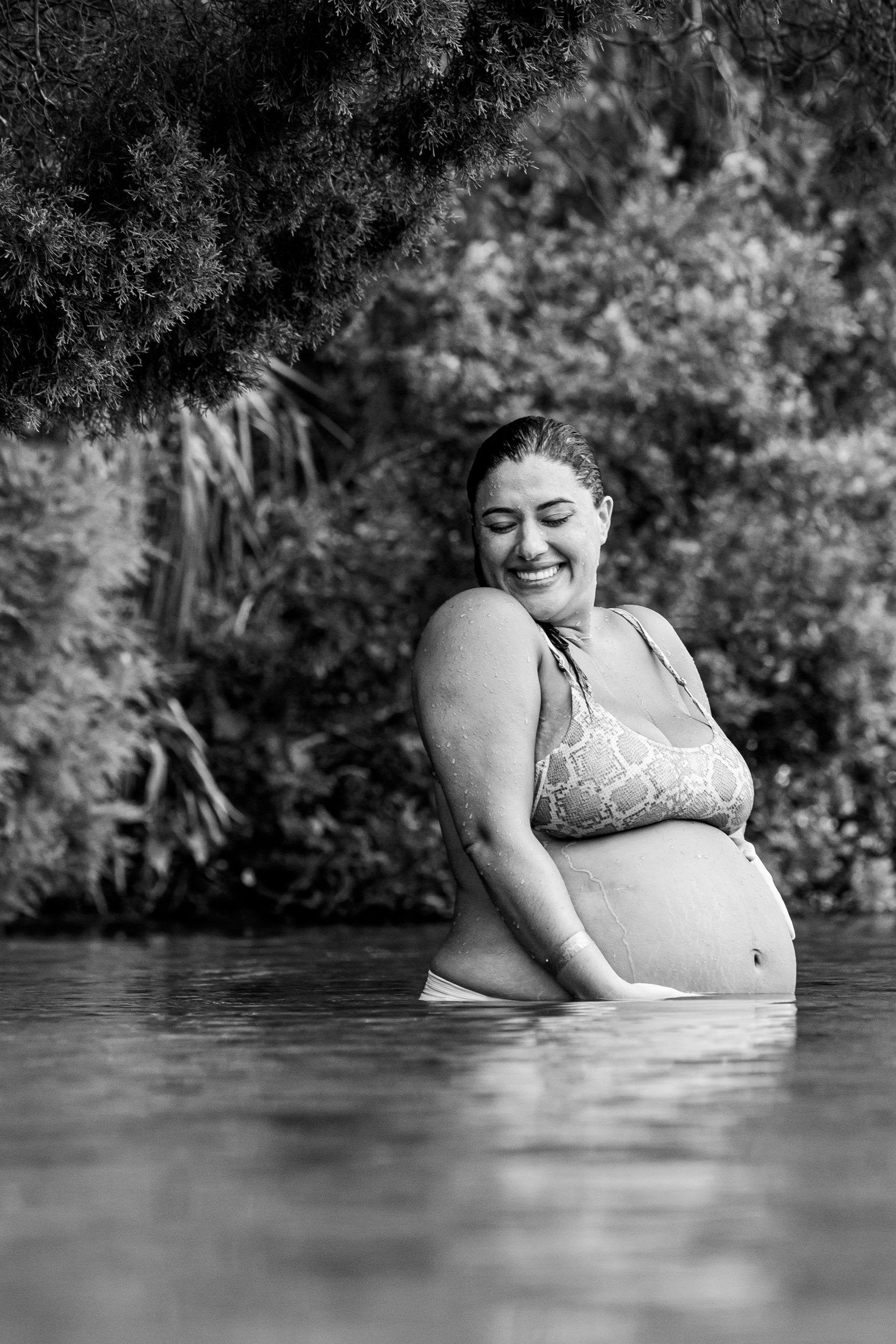 jacksonville mom smiling as she shrugs her shoulders while standing in the springs