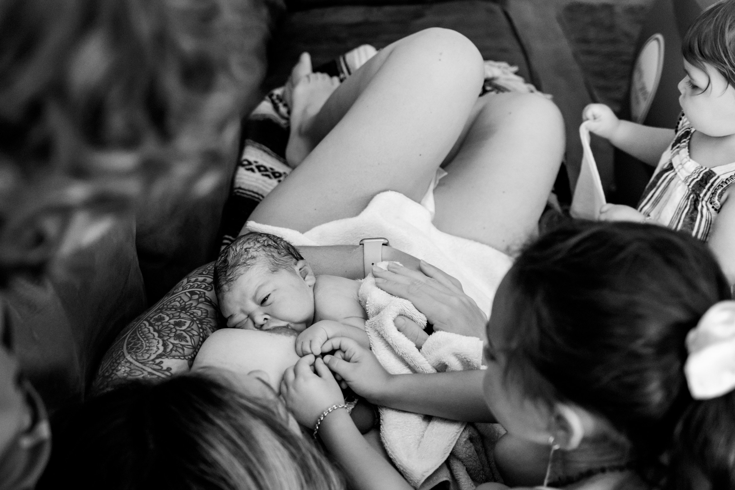 newborn baby girl breastfeeding just after birth