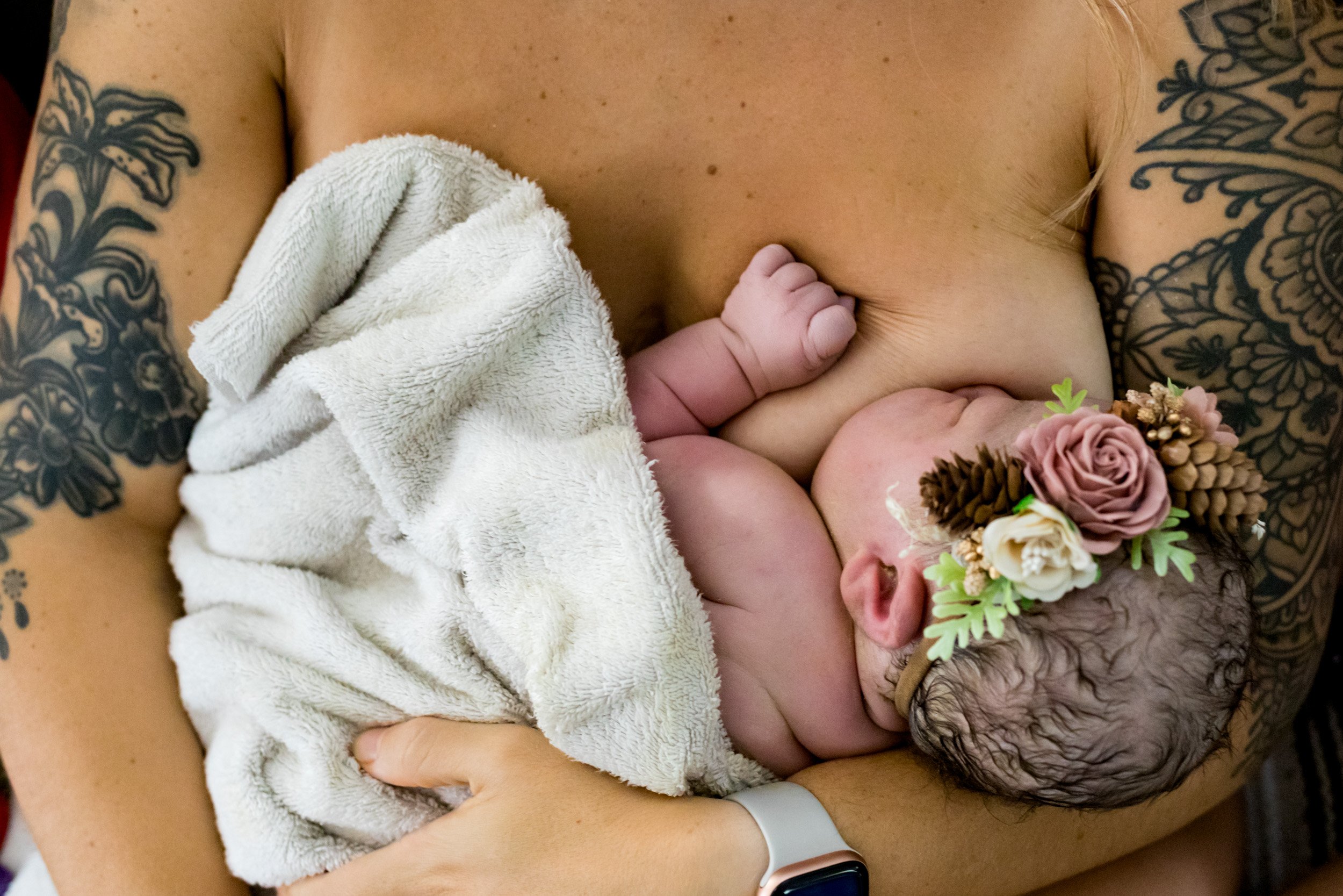 mom holding her newborn baby girl, just after birth
