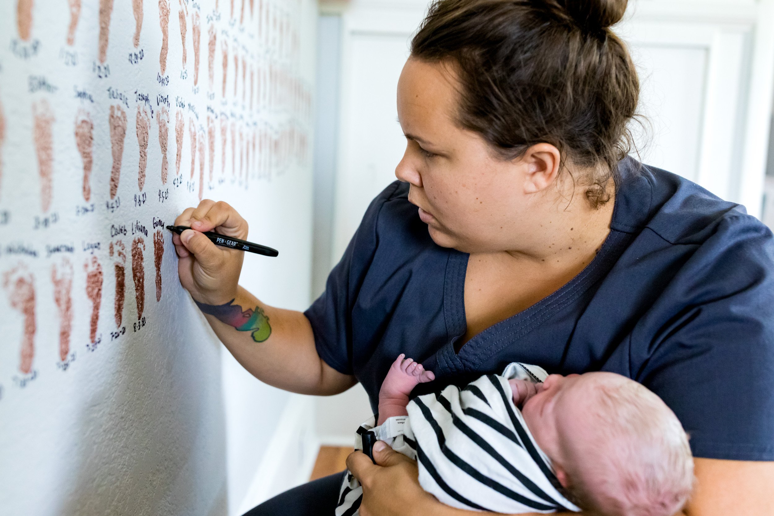 midwife writing the name of the baby on the wall