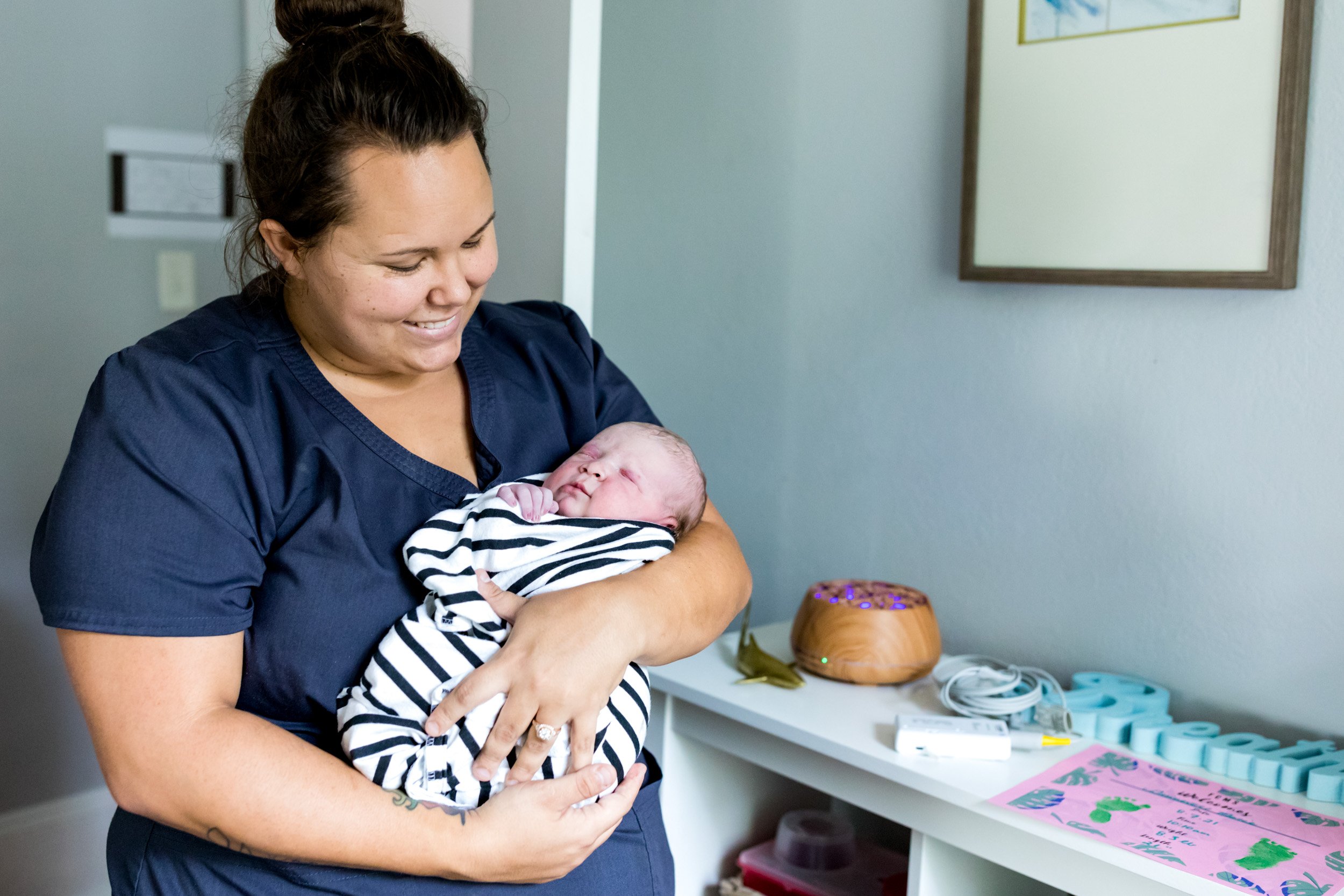 First Coast Midwifery's Midwife Sam holding baby girl just after birth