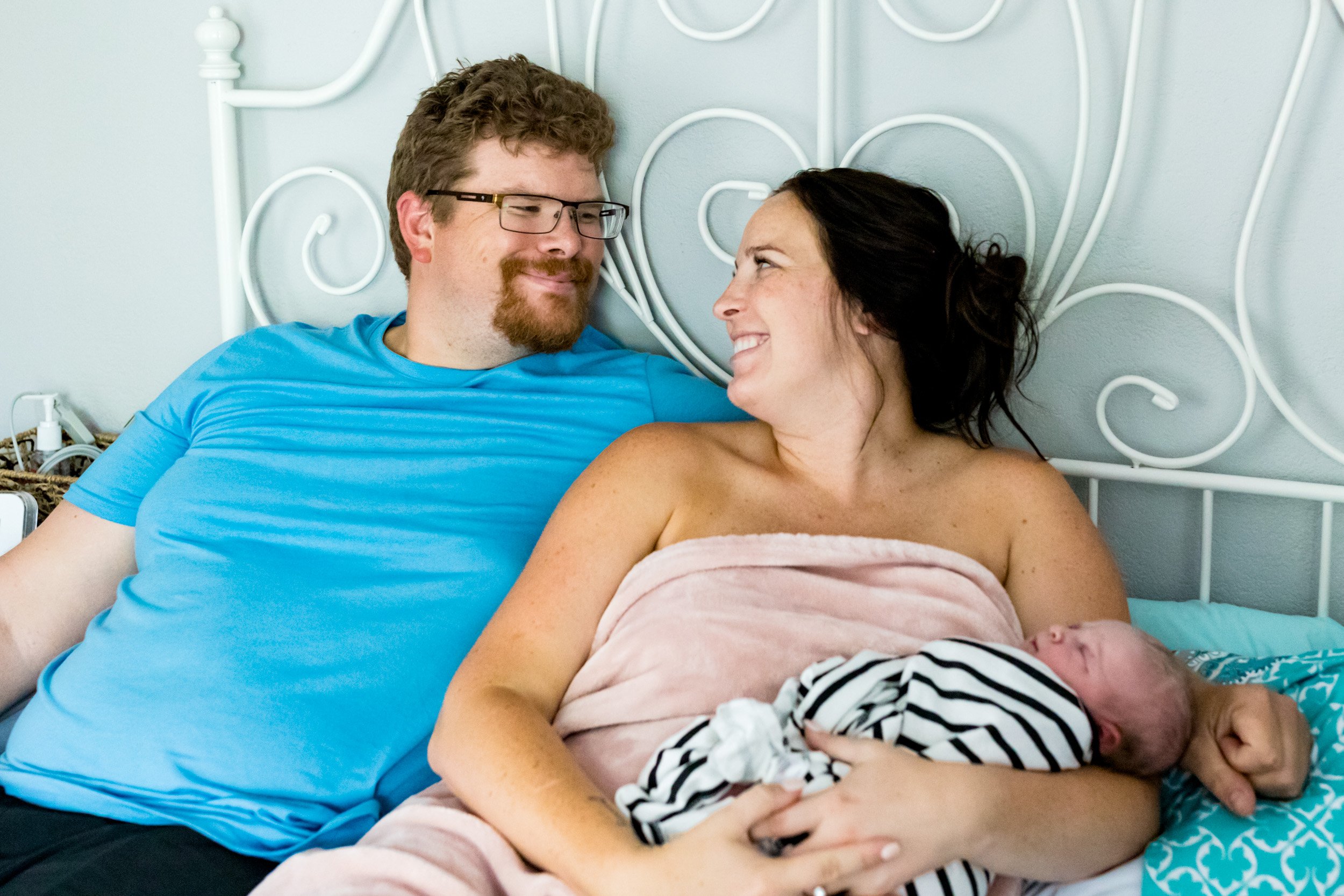 Jacksonville parents smiling at each other just after the birth of their baby girl
