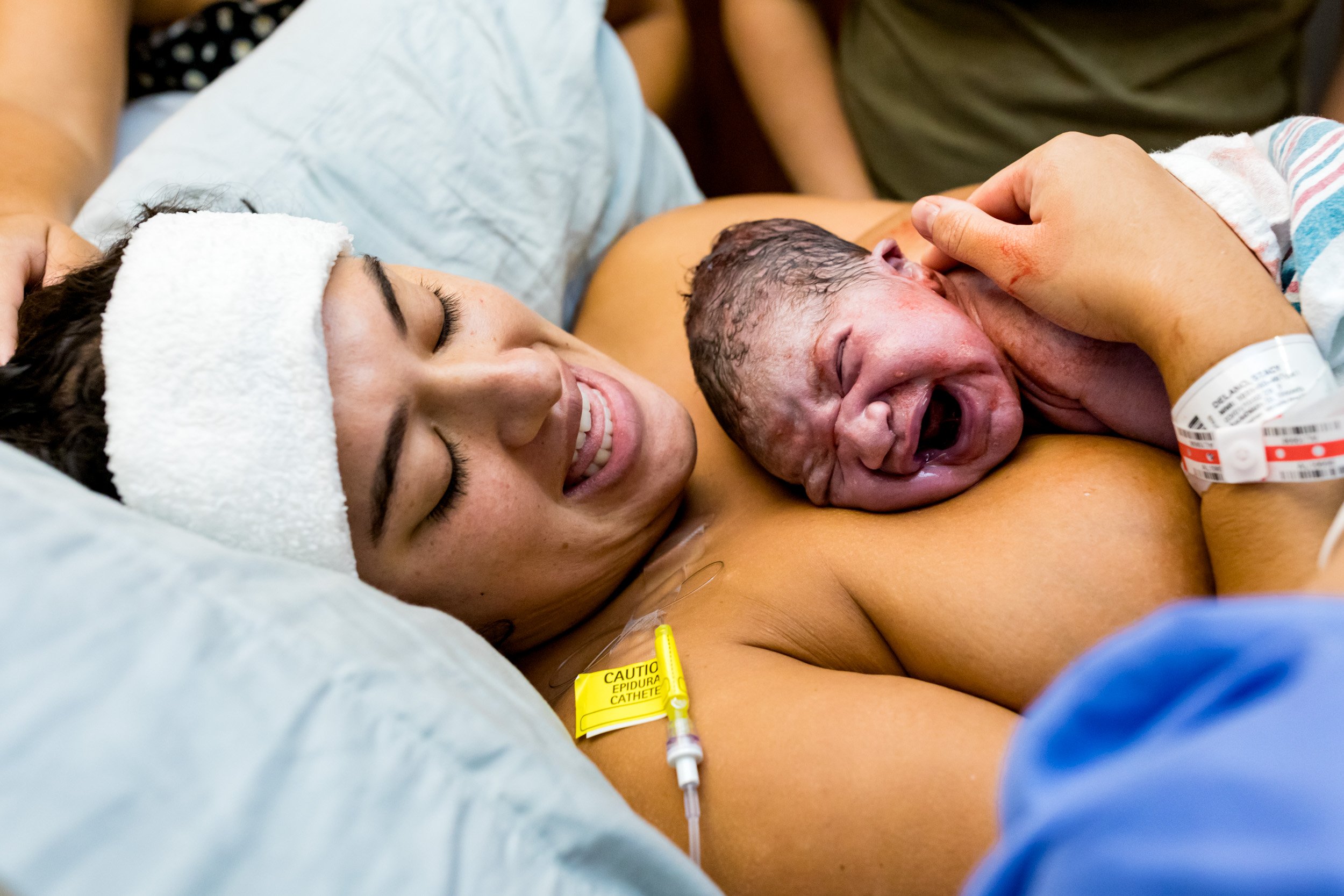 jacksonville mom holding her baby on her chest just after birth