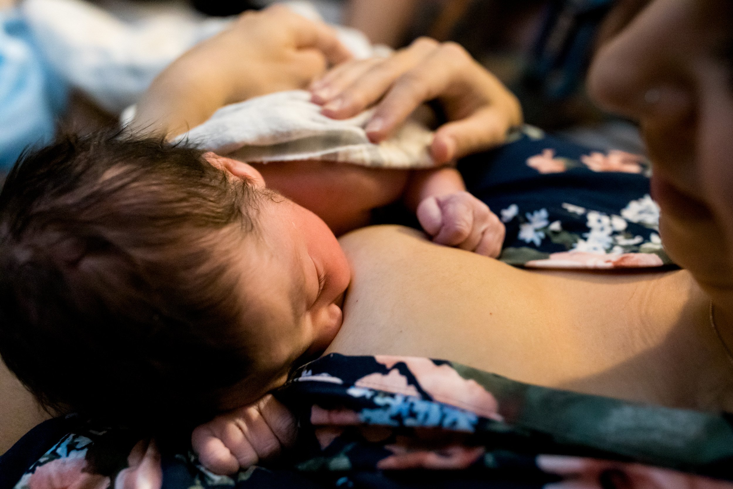 newborn baby girl breastfeeding