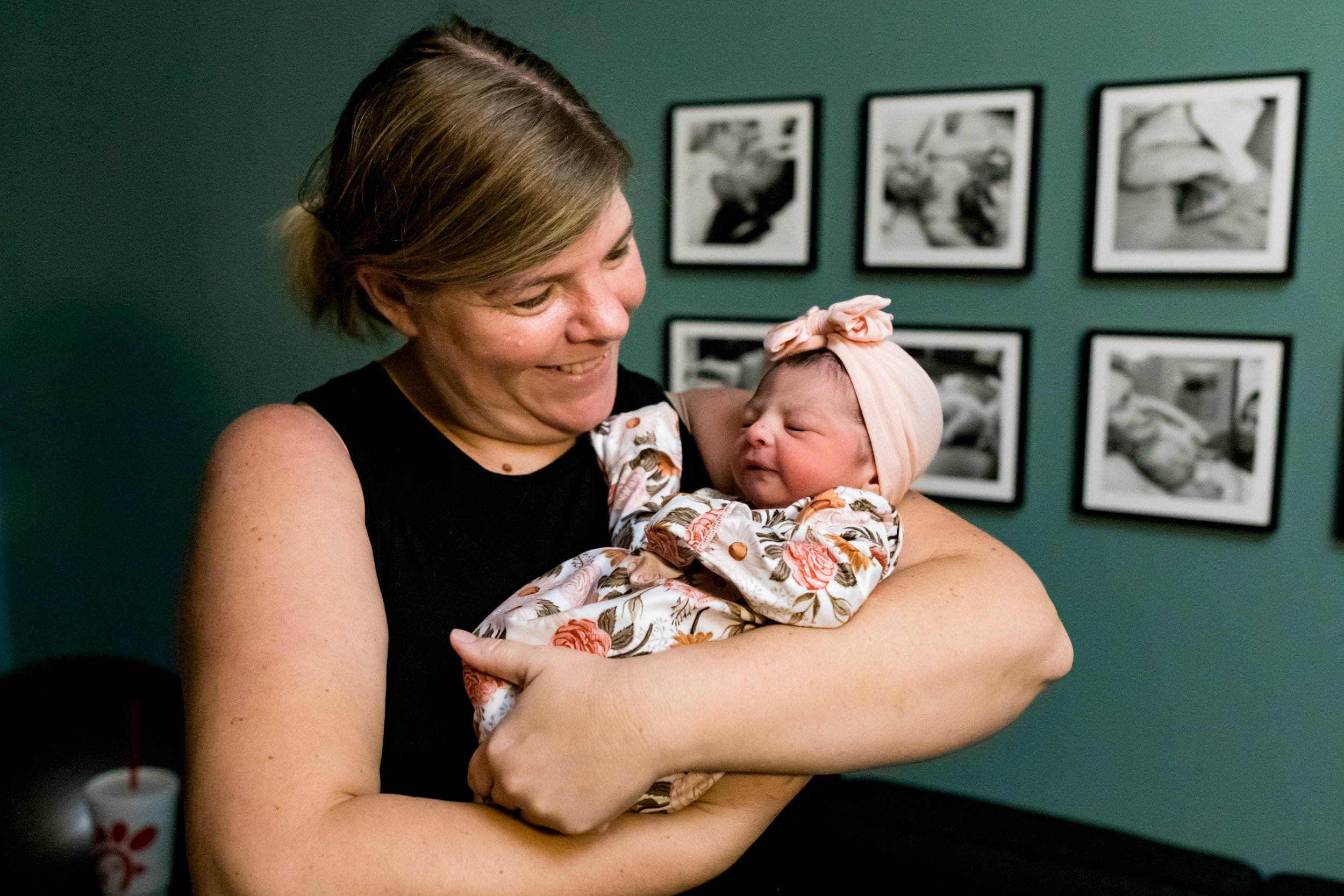 birth doula holding newborn baby just after birth