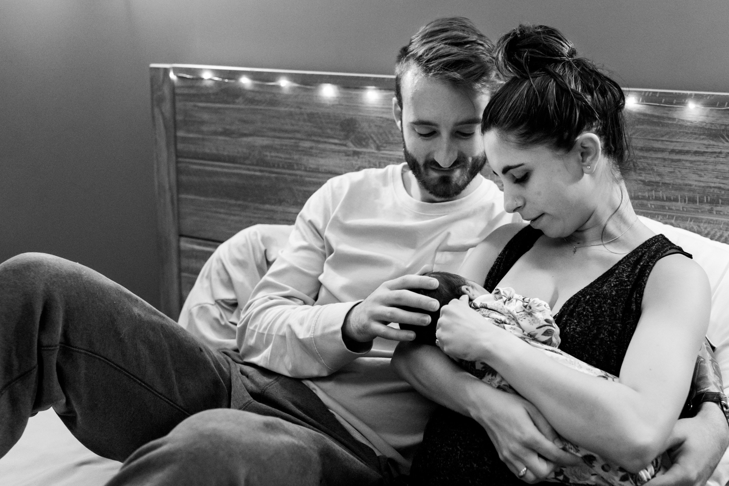 new parents looking at baby girl just after birth