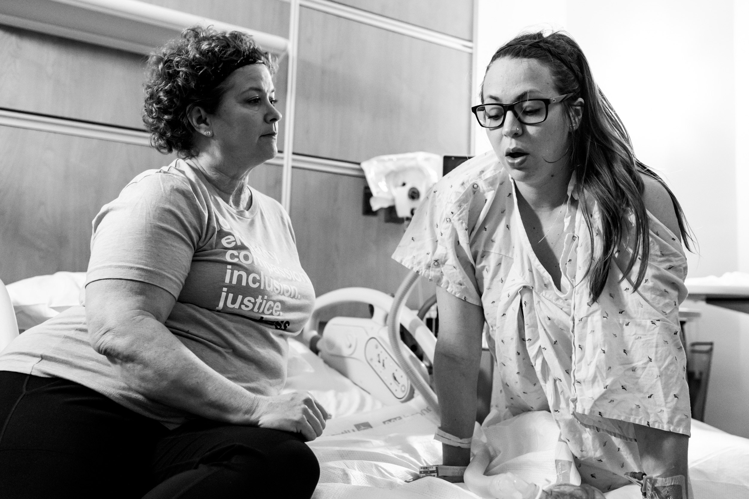 pregnant mom breathing through a contraction with her doula alongside her
