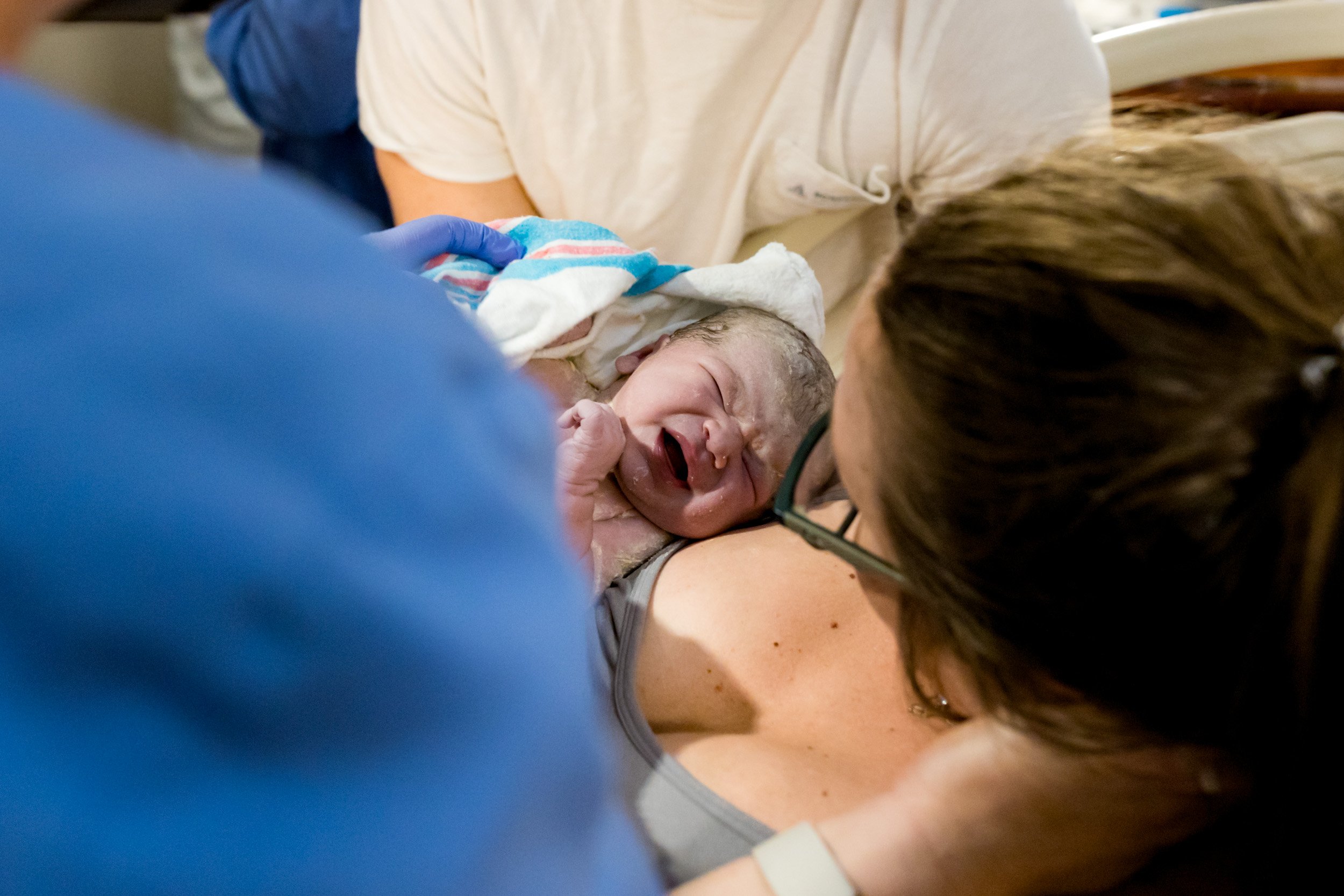 newborn baby girl resting on her mama's chest