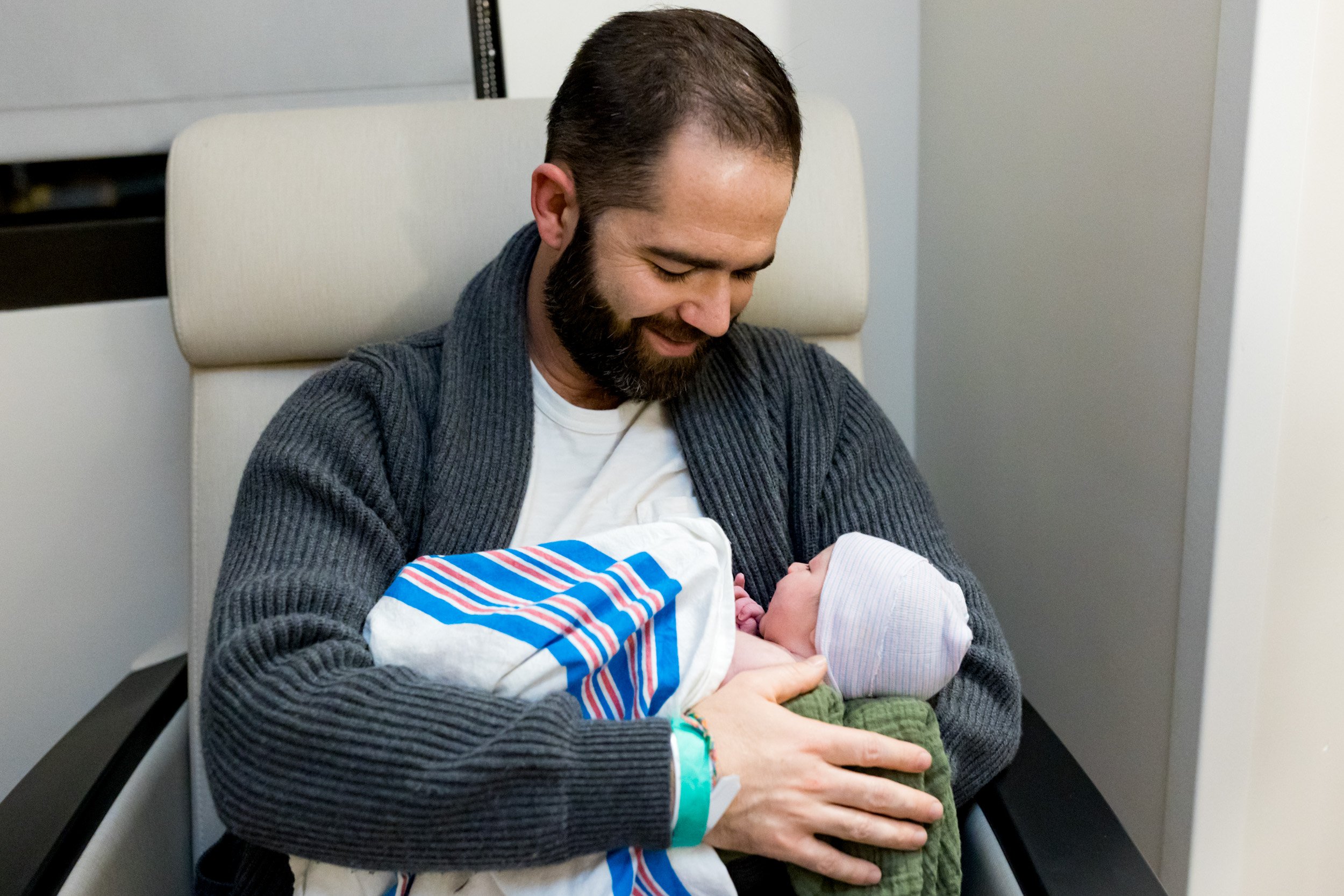 jacksonville dad smiling at his newborn daughter