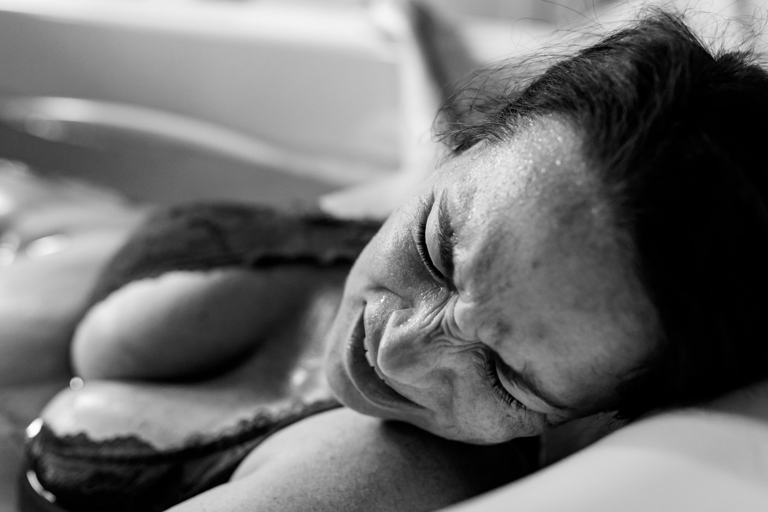 birth mom with strain on her face during labor