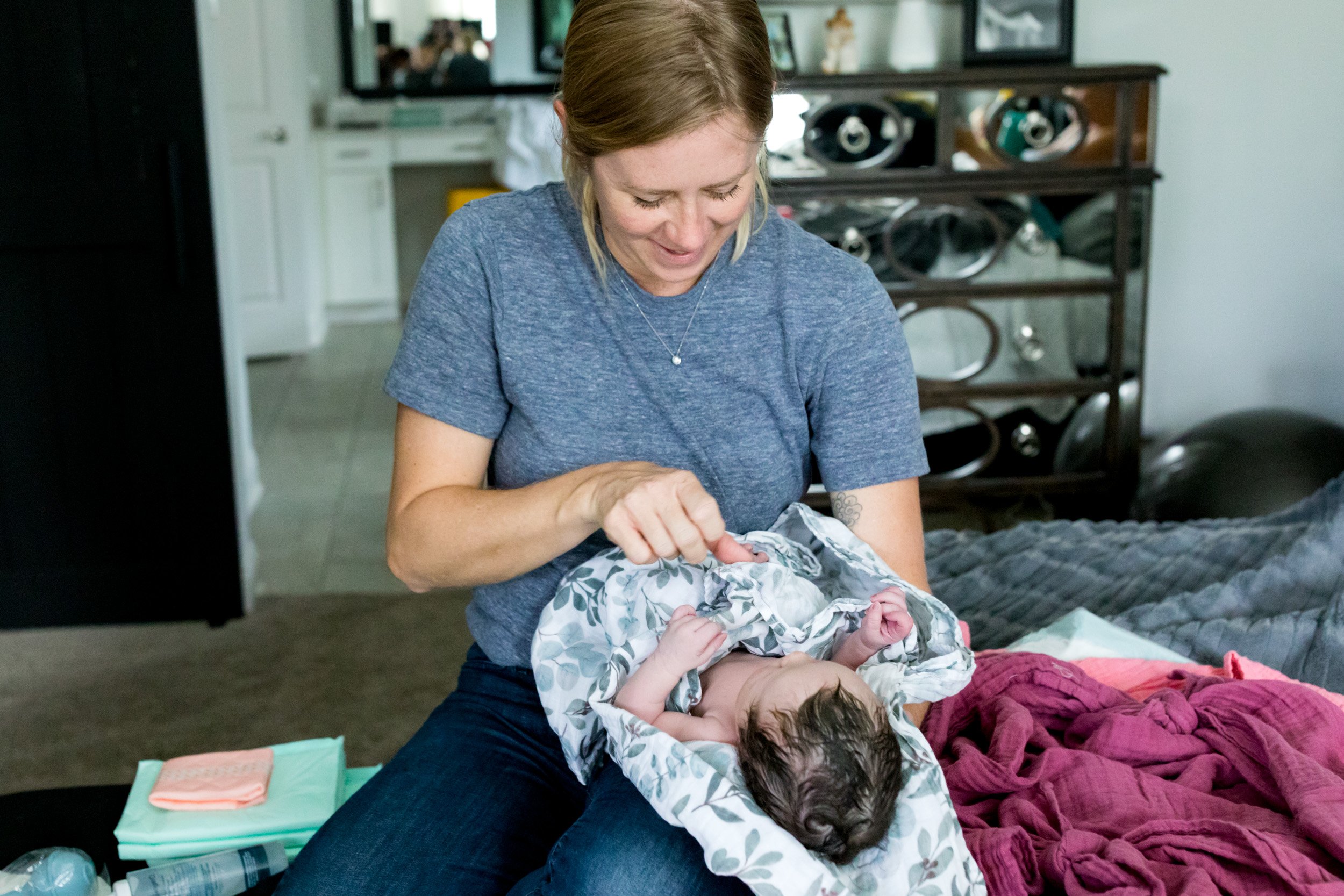 midwife holding newborn baby girl