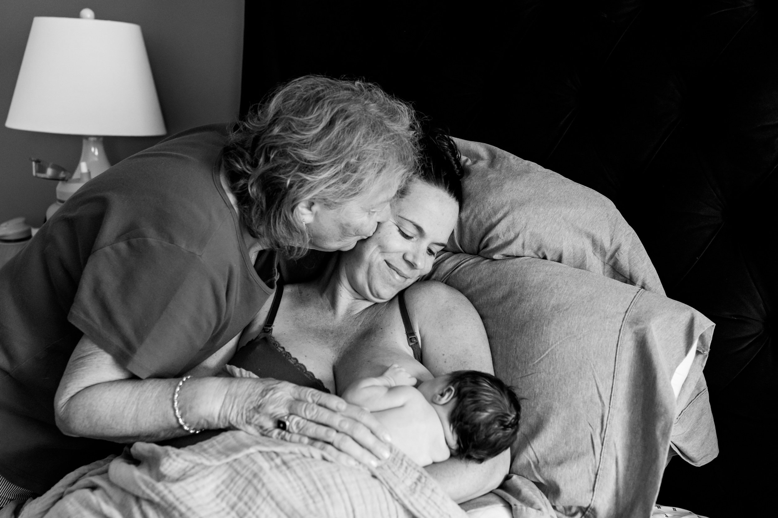 three generations of girls - grandma, mom, and new baby just after birth