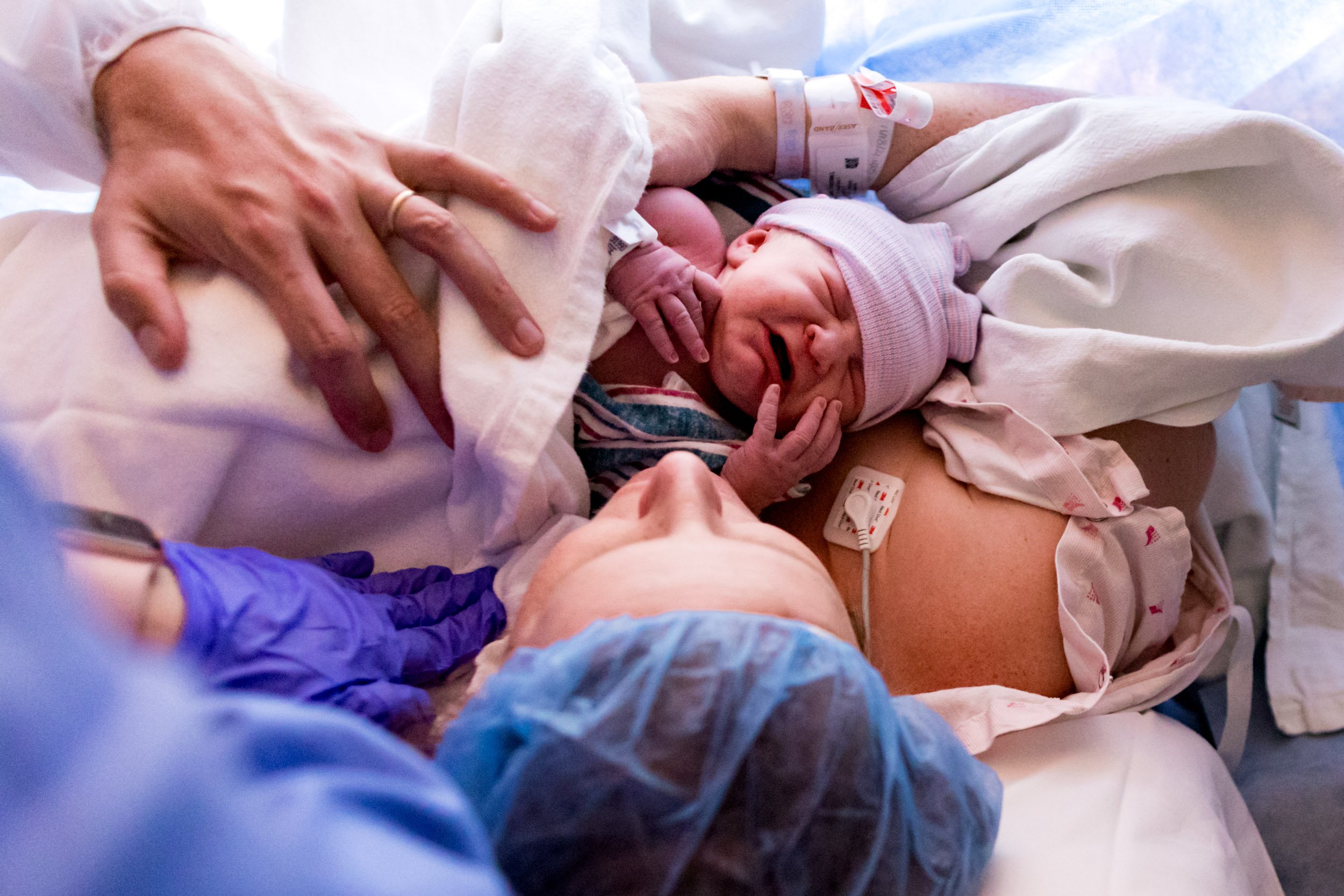 mom holding baby on chest just after birth
