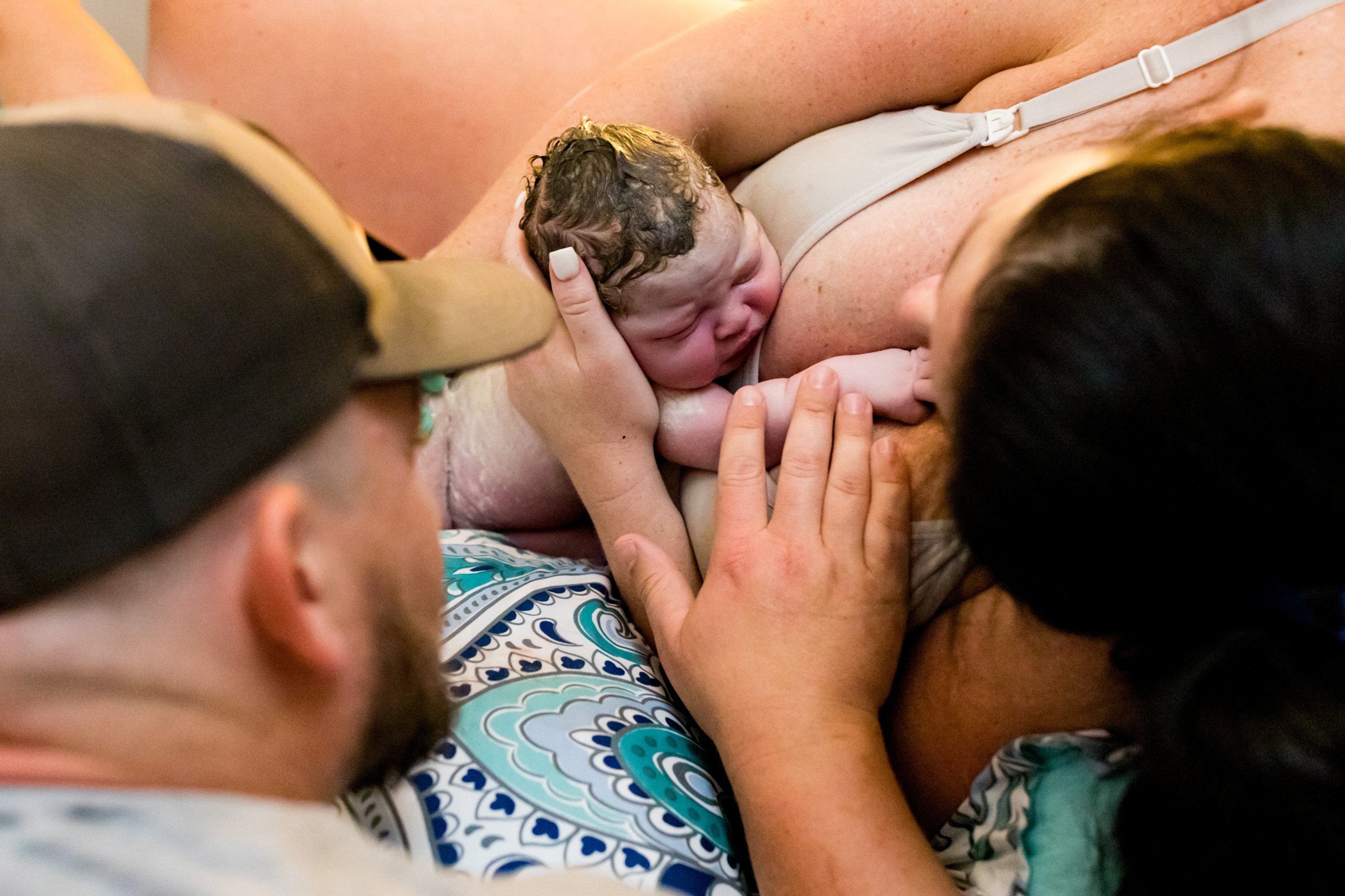 birth parents looking at their baby girl right after she was born