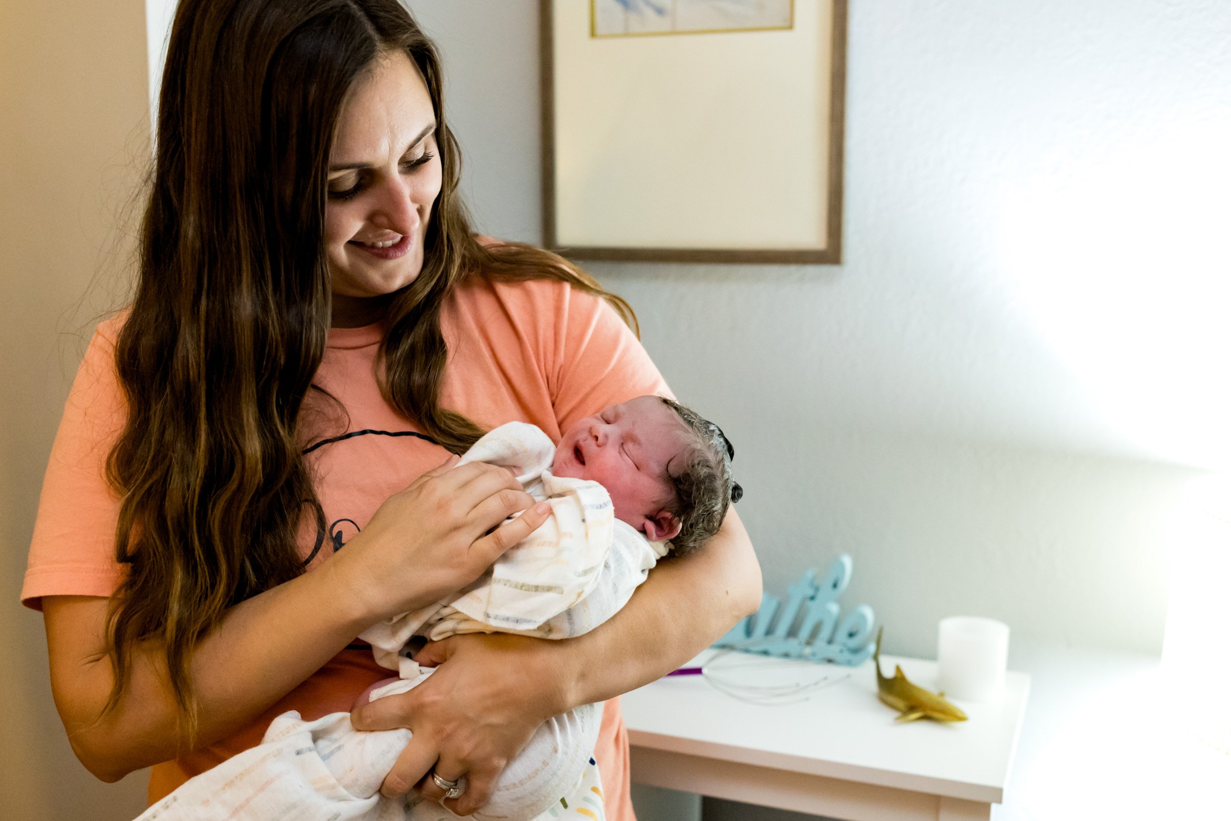 doula holding newborn baby girl