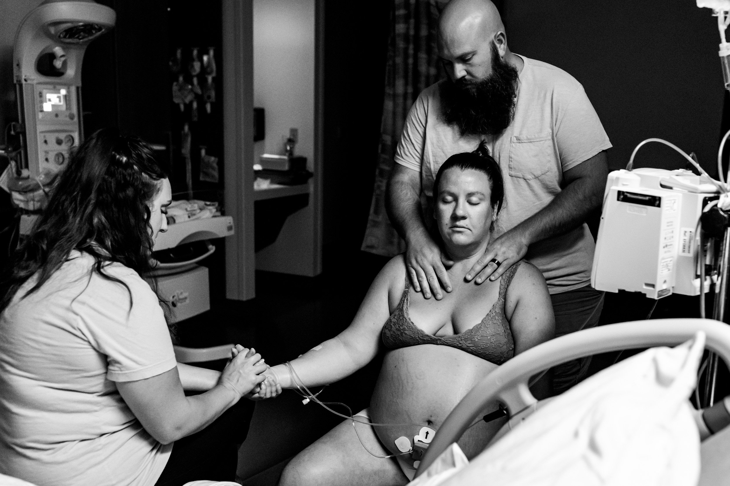 husband and doula massaging birth mom in labor