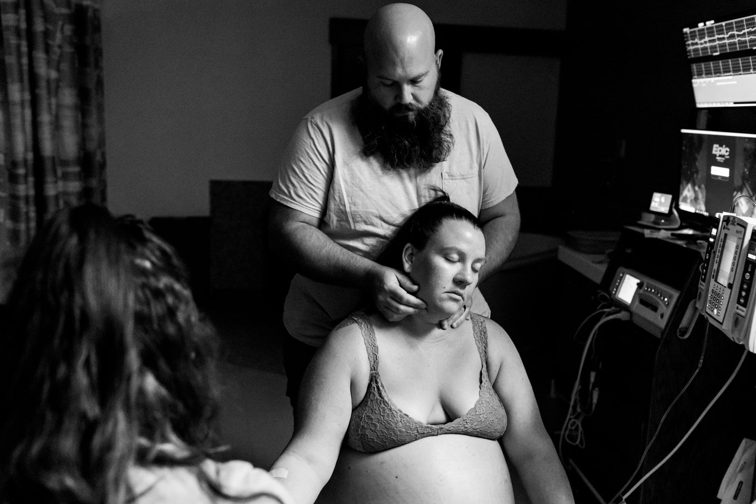 husband massaging pregnant wife's neck