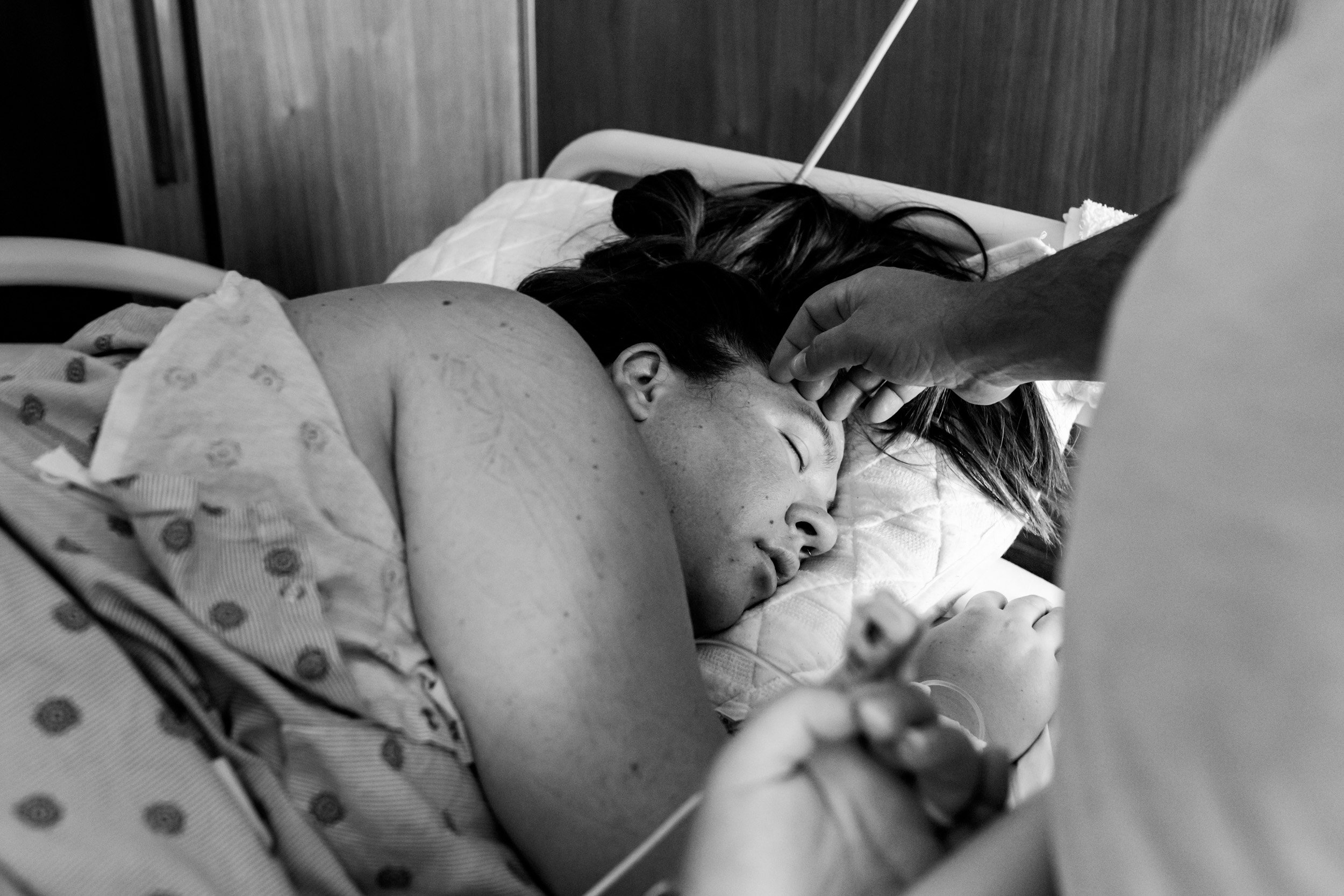 husband placing hand on pregnant's wife forehead