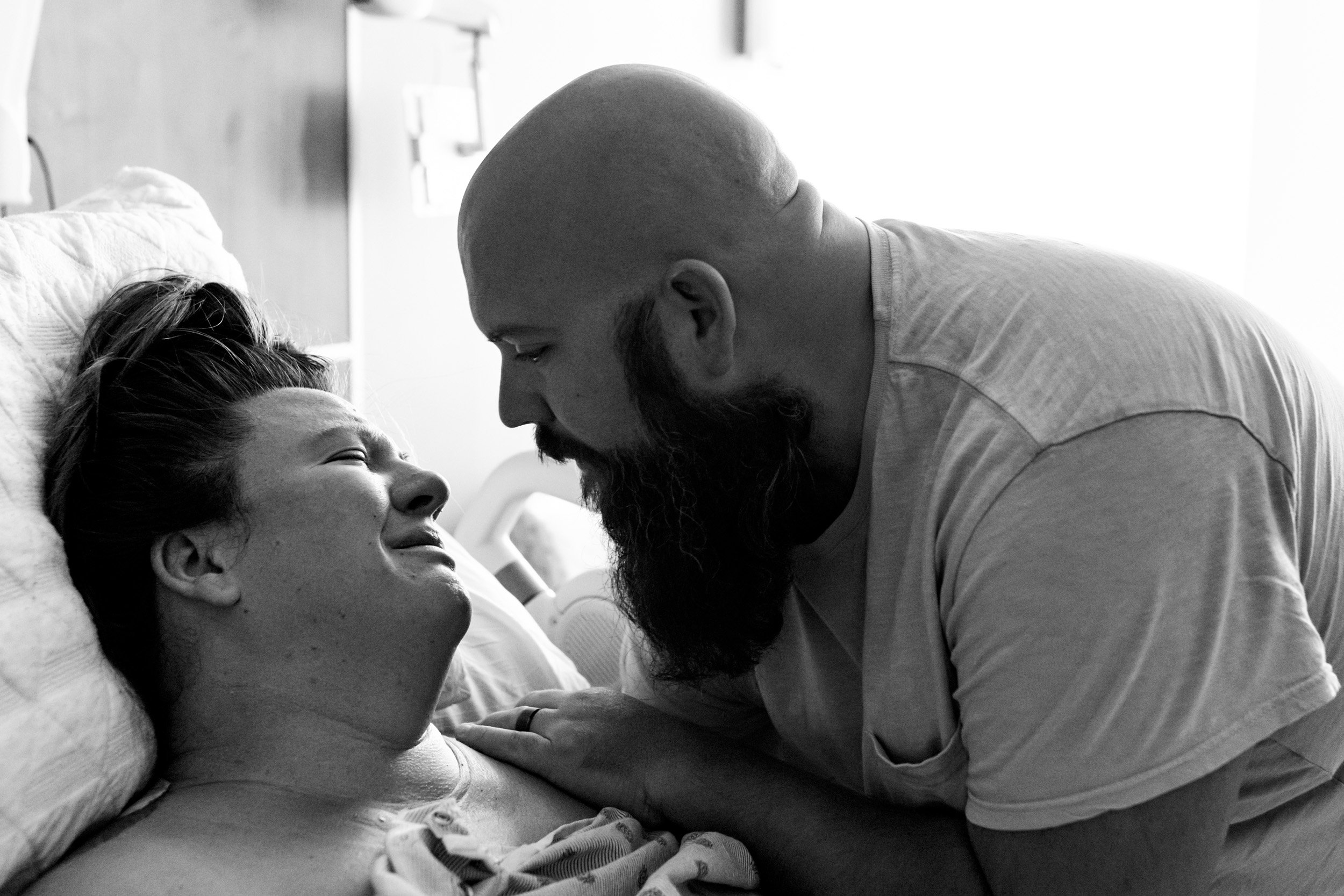 husband comforting crying wife after she just learned she needs a c-section