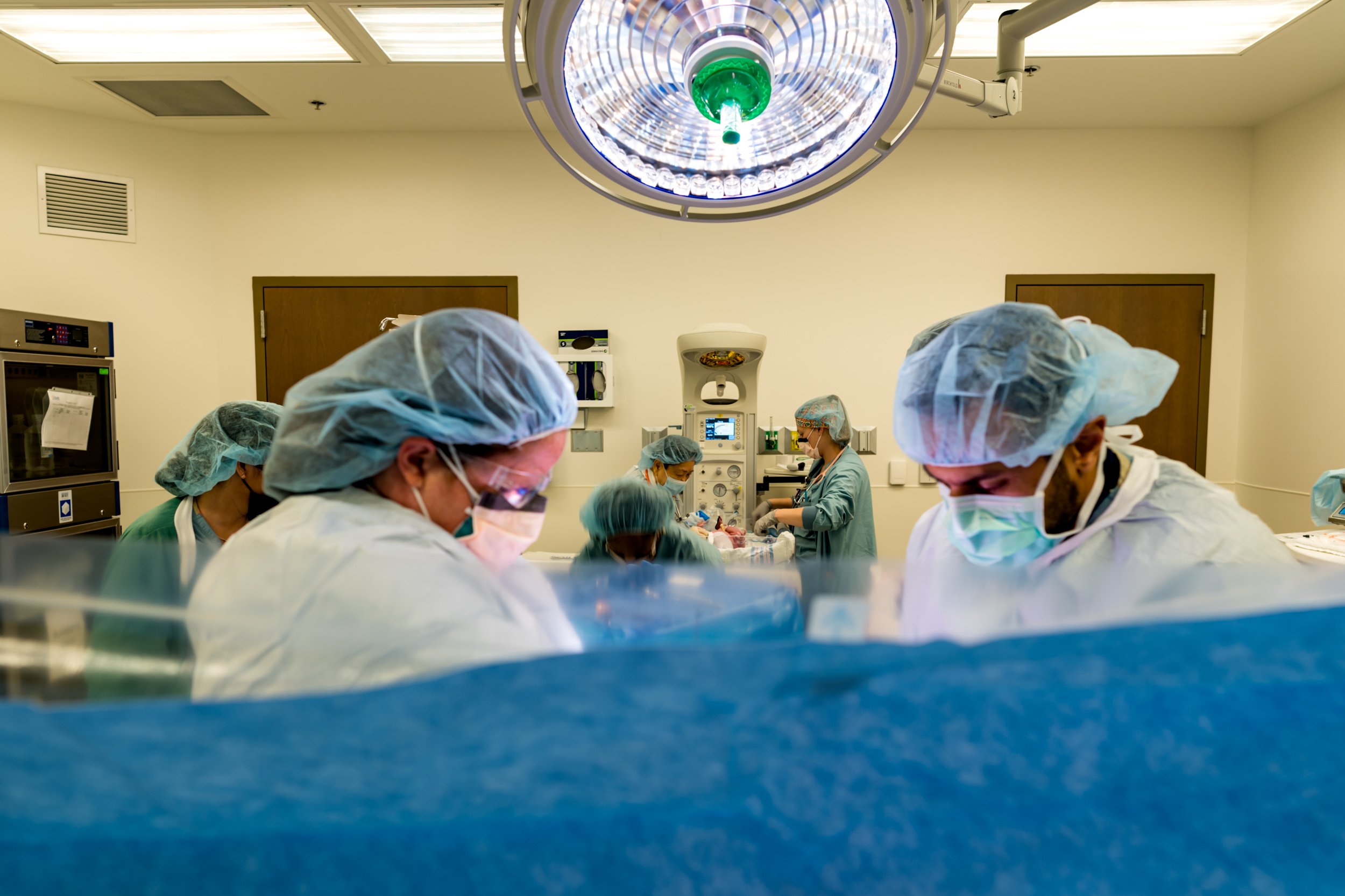 doctors finishing c-section
