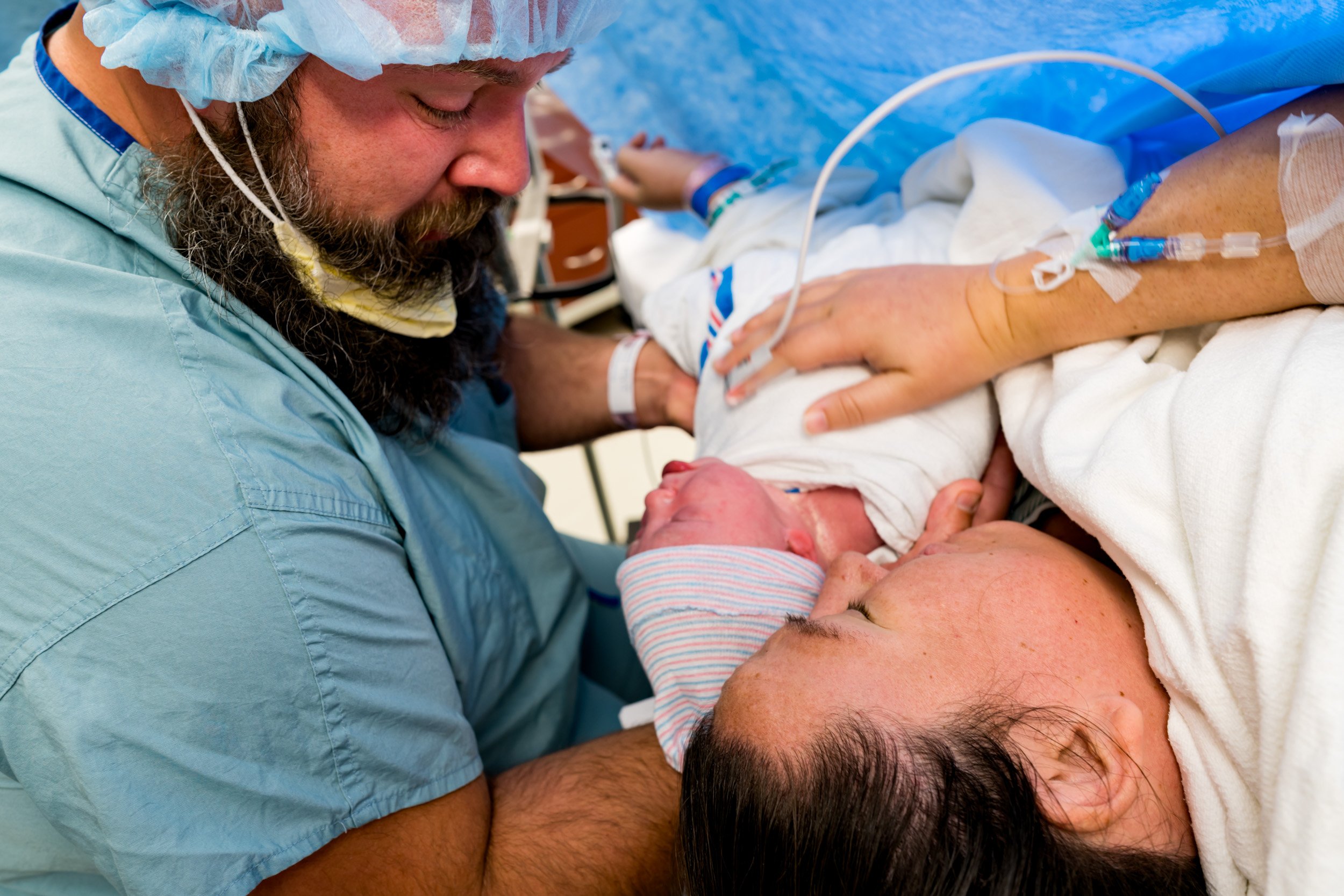 birth parents holding newborn baby girl in OR