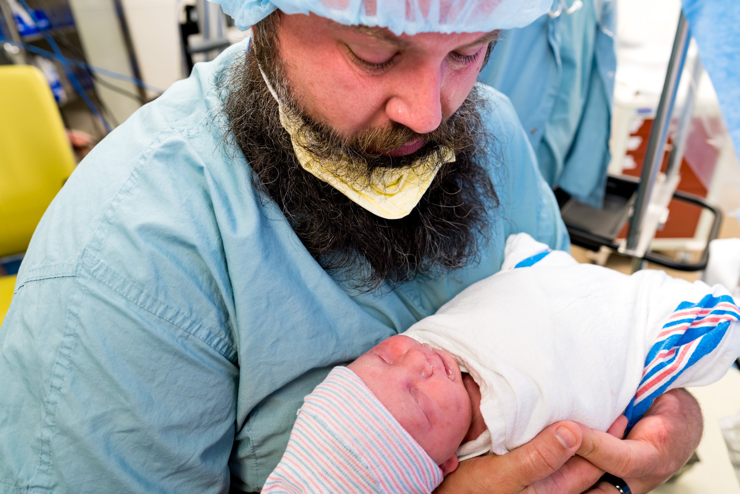 birth dad holding newborn baby