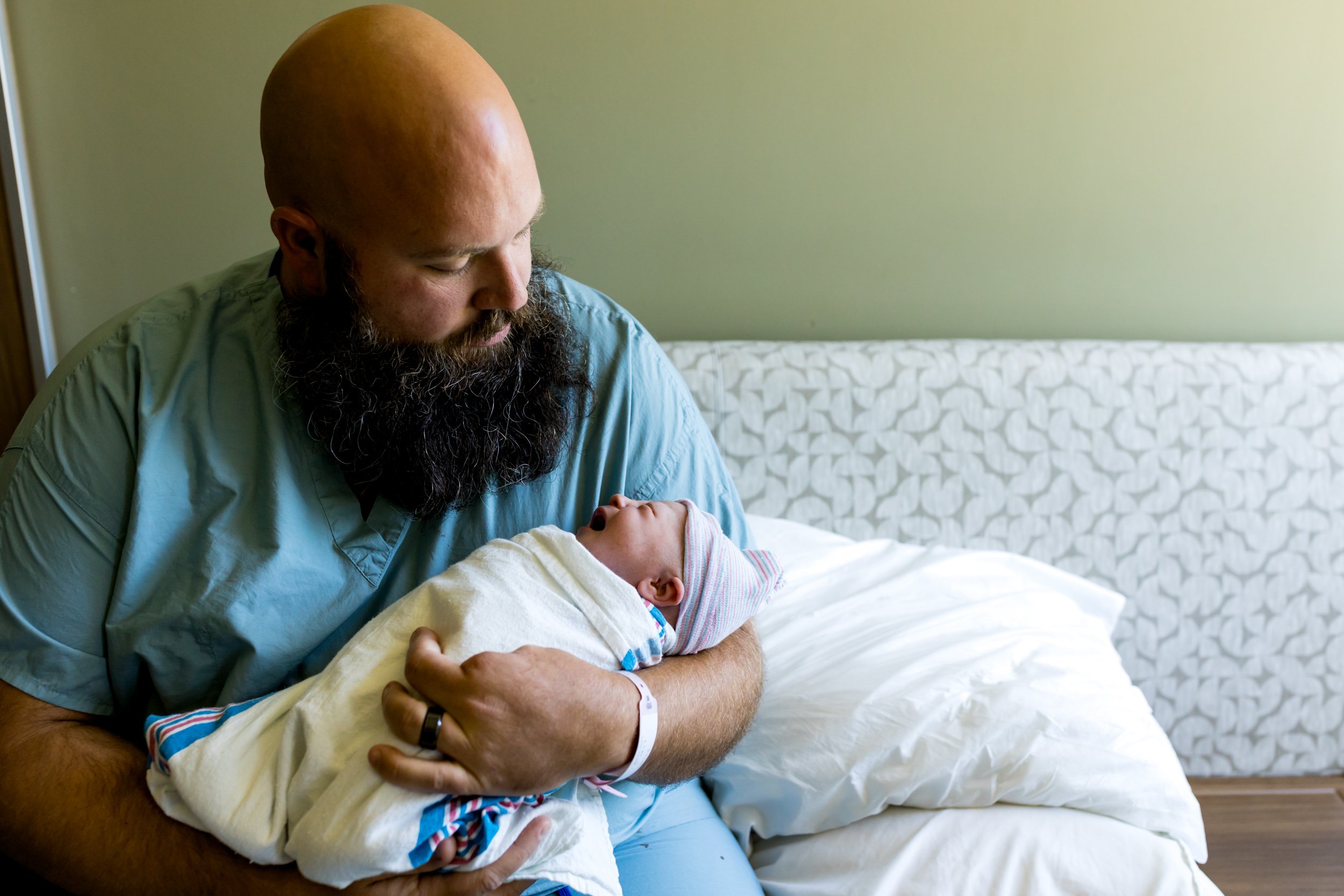 dad holding newborn baby girl