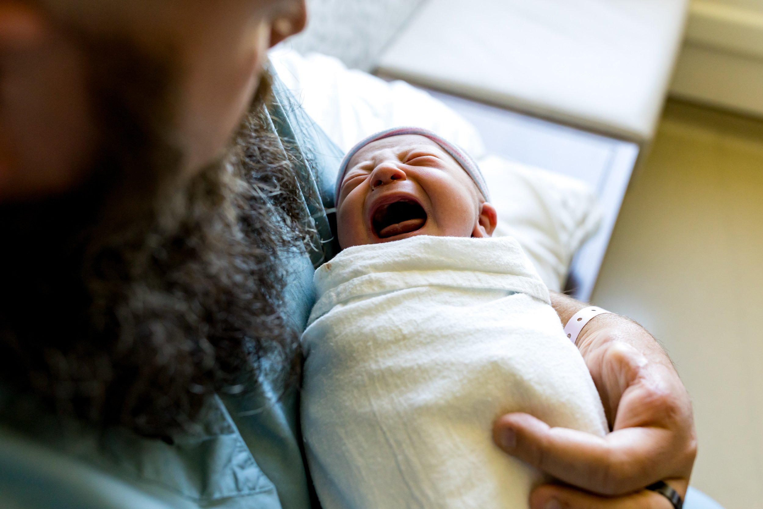 newborn baby being held by her dad