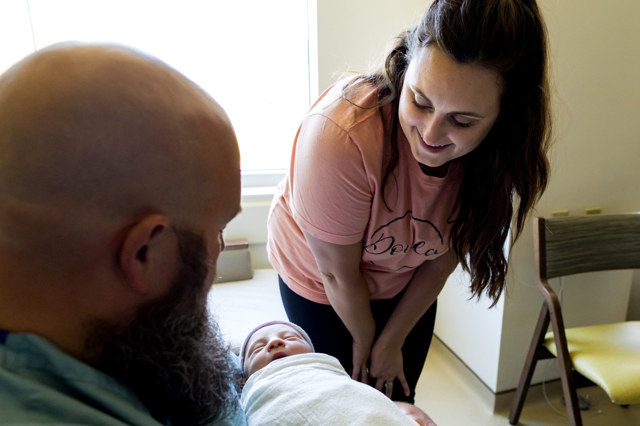 doula looking at newborn baby girl