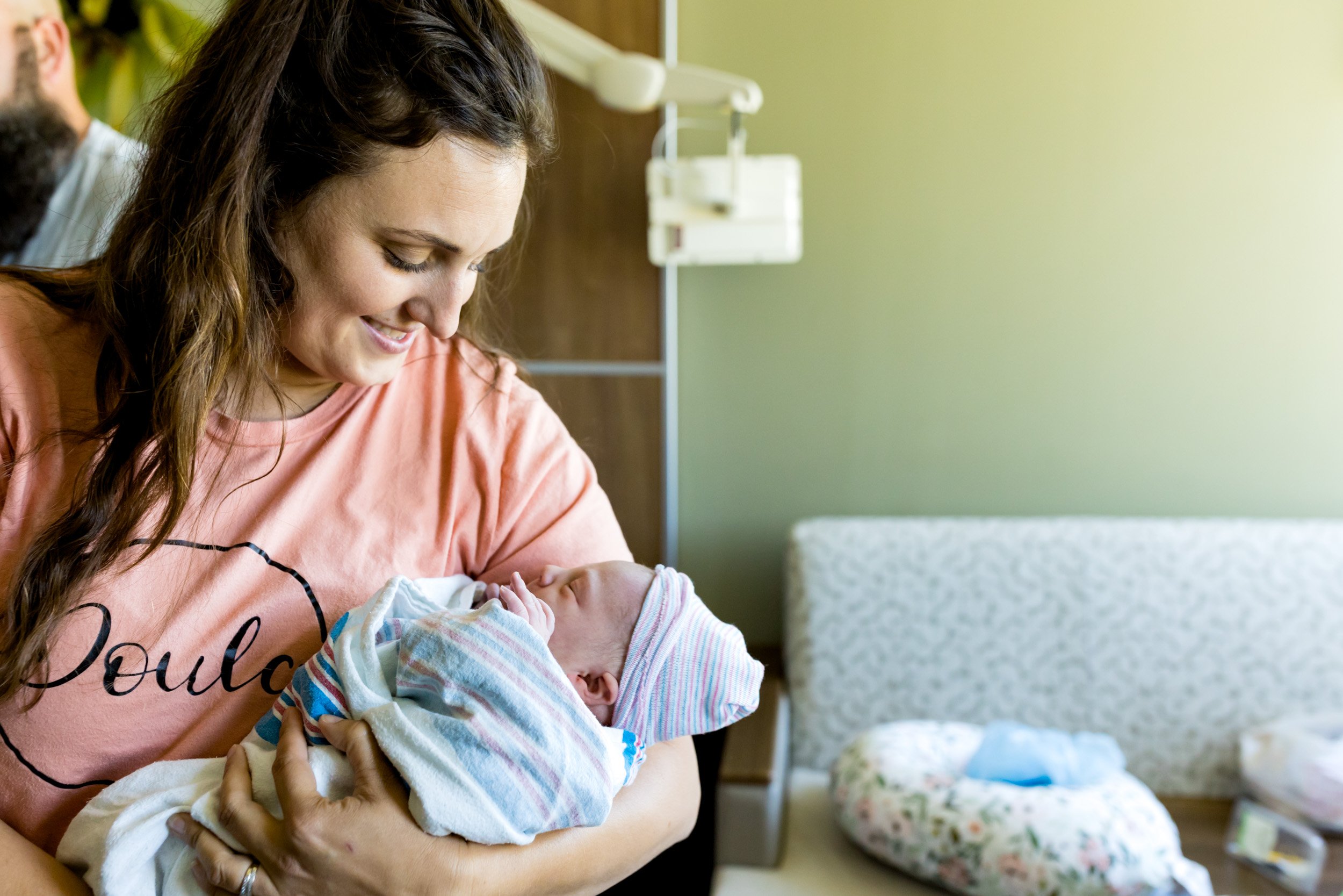 doula holding newborn baby