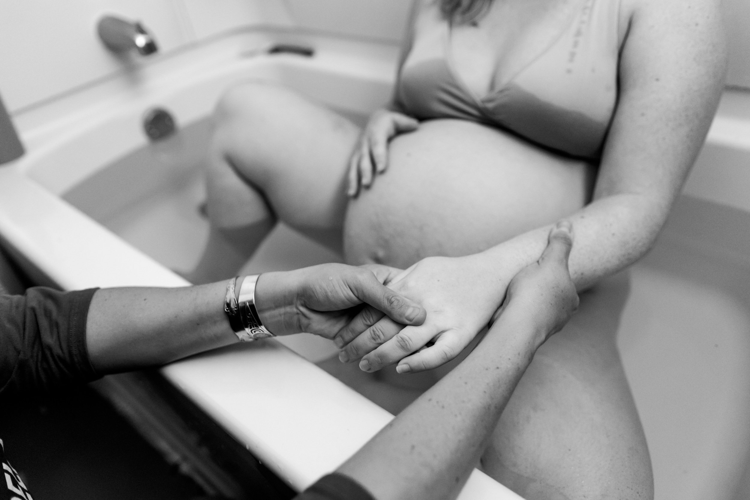 birth doula massaging pregnant mom's hands