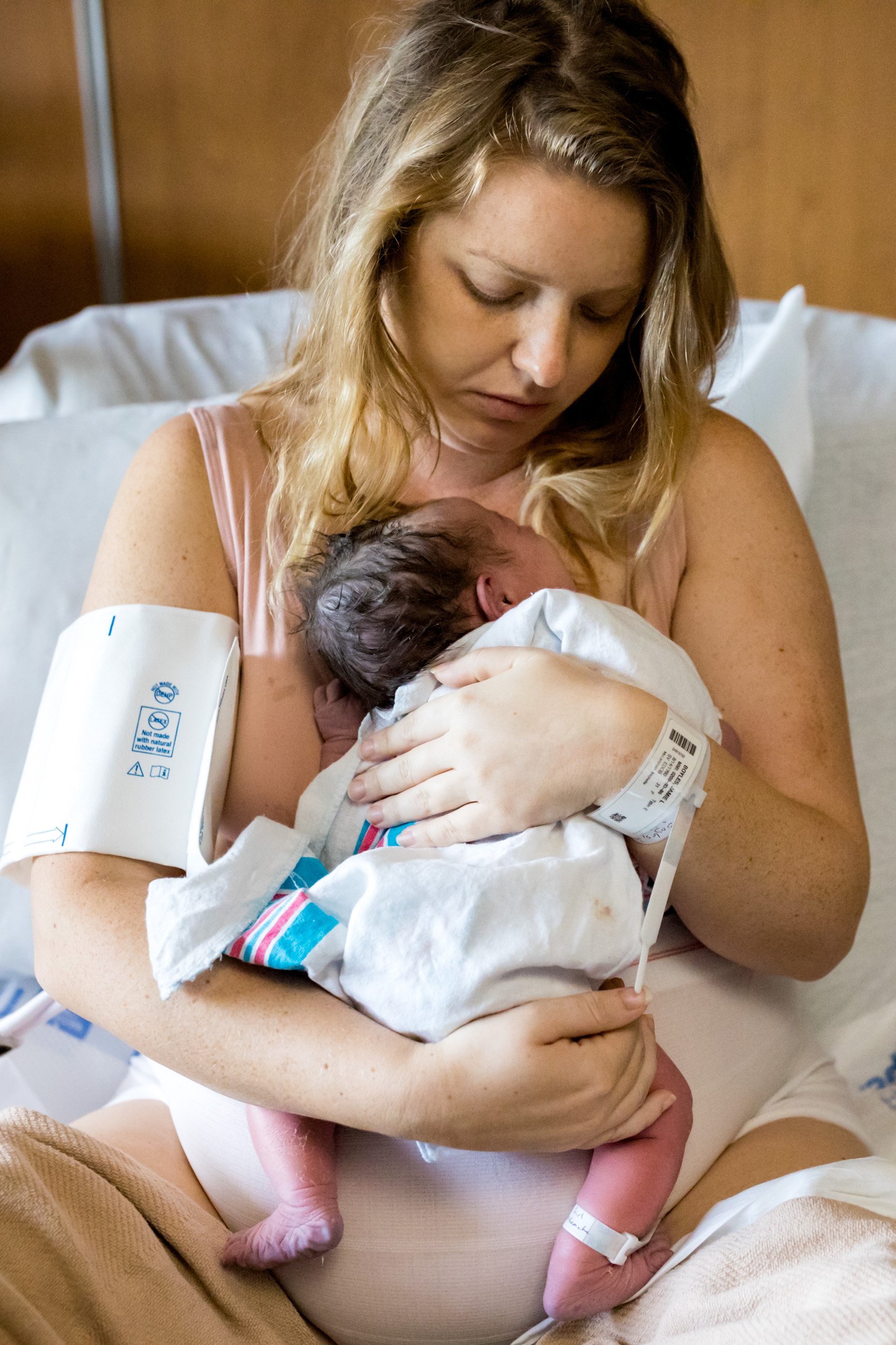 birth mom holding her baby girl against her skin